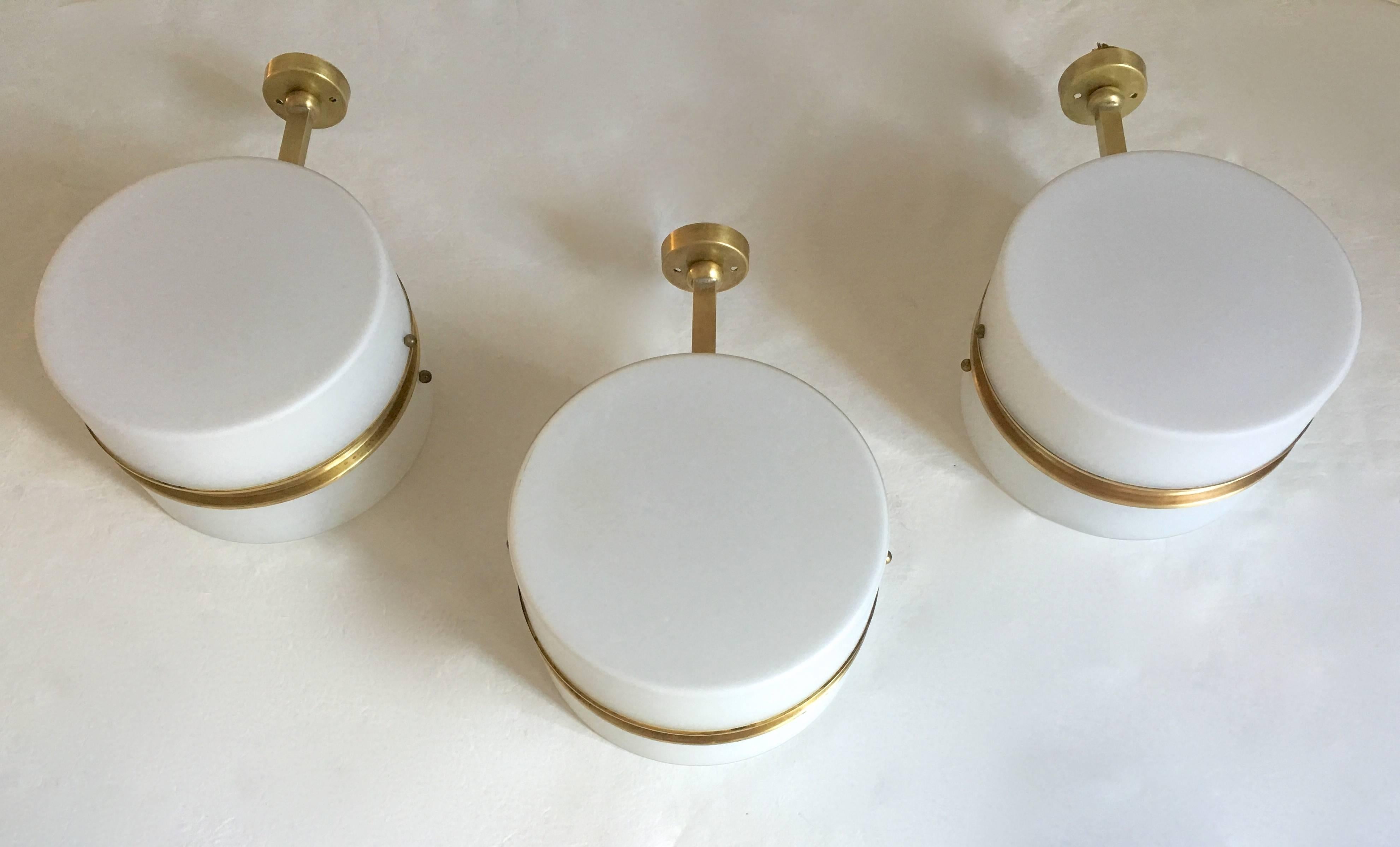 Very nice set of voluminous round wall lights braced by a brass band and arm.
High quality manufacture from Milan, Italy, circa 1960.
 