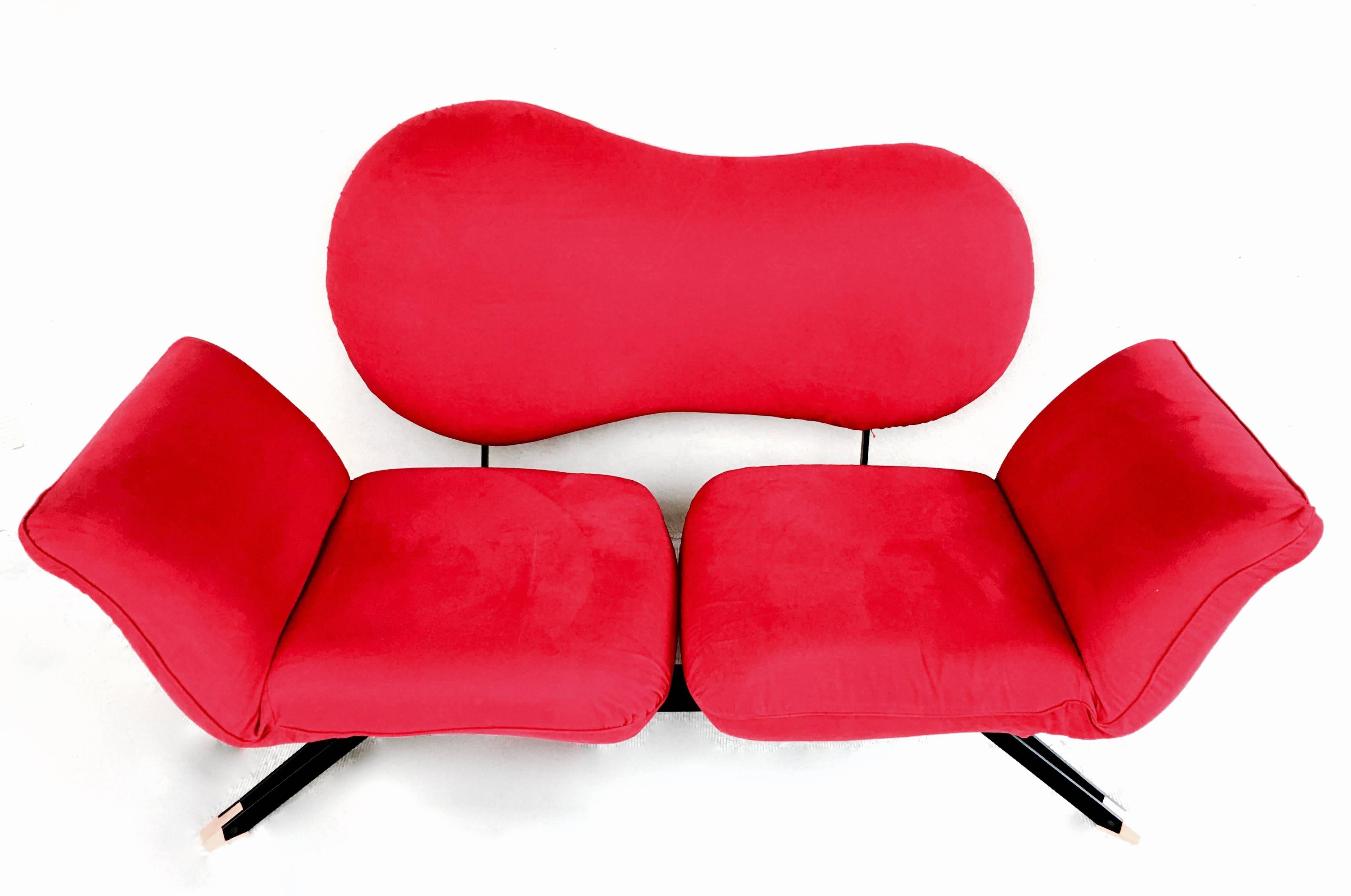 Sculptural Postmodern sofa of Italian manufacture circa 1989. Organic shaped backrest and flexible seat and armrests in bright red. Set on a black enamelled frame with beechwood feet. Excellent details such as the open framed feet and the open