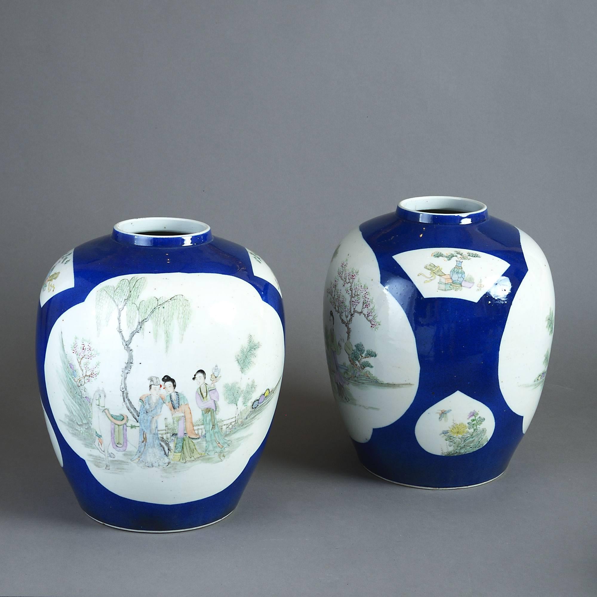 A pair of late 19th century porcelain jars of good scale having figurative cartouches depicting court scenes on a dark blue ground.