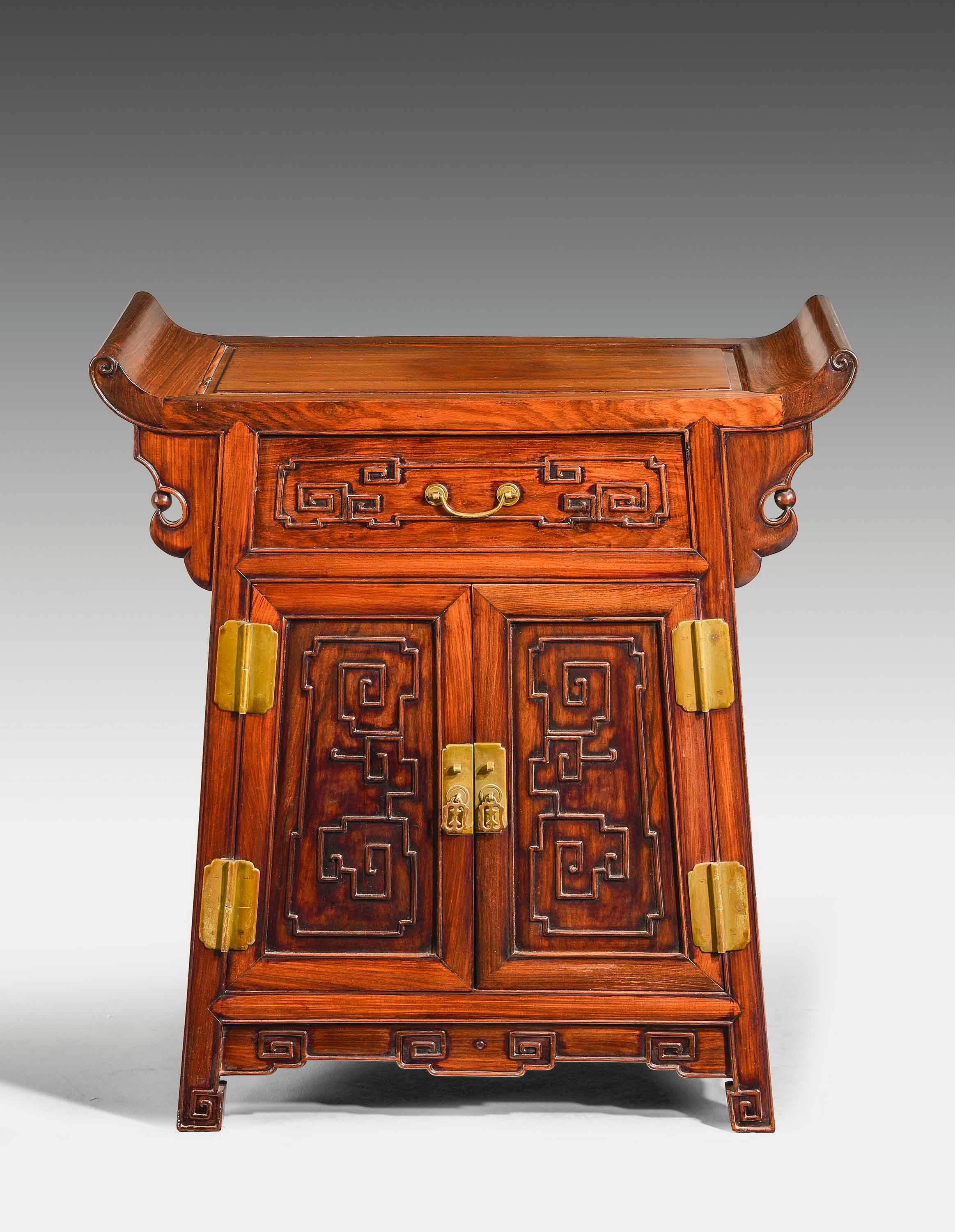 A wonderful quality Chinese hardwood side cabinet. With a flared dish top, the carving of the timbers of the very best quality and retaining the original brassware. 

RR.