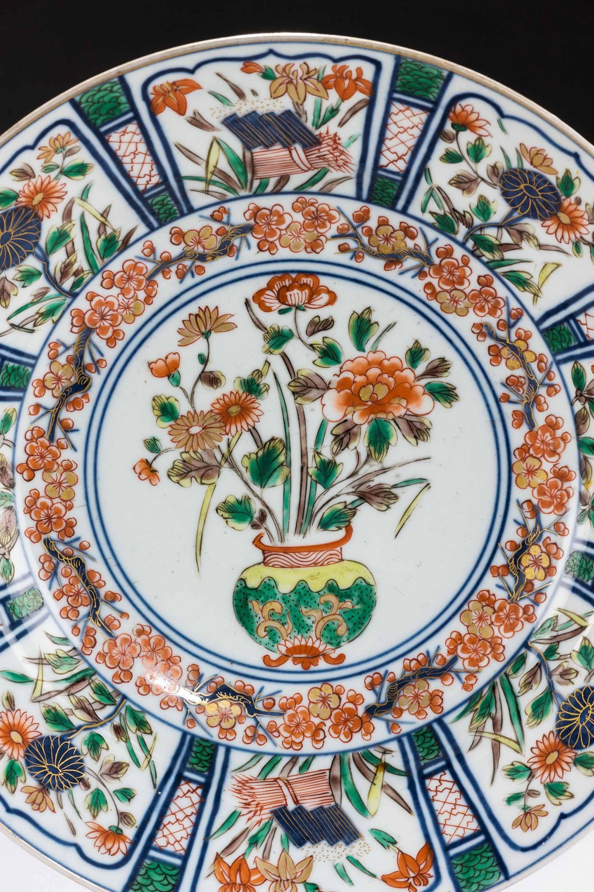 Second half 19th century Imari porcelain charger, with iris and peonies foliage. 

Imari began to be exported to Europe, because the Chinese kilns at Ching-te-Chen were damaged in the political chaos and the new Qing dynasty government stopped trade
