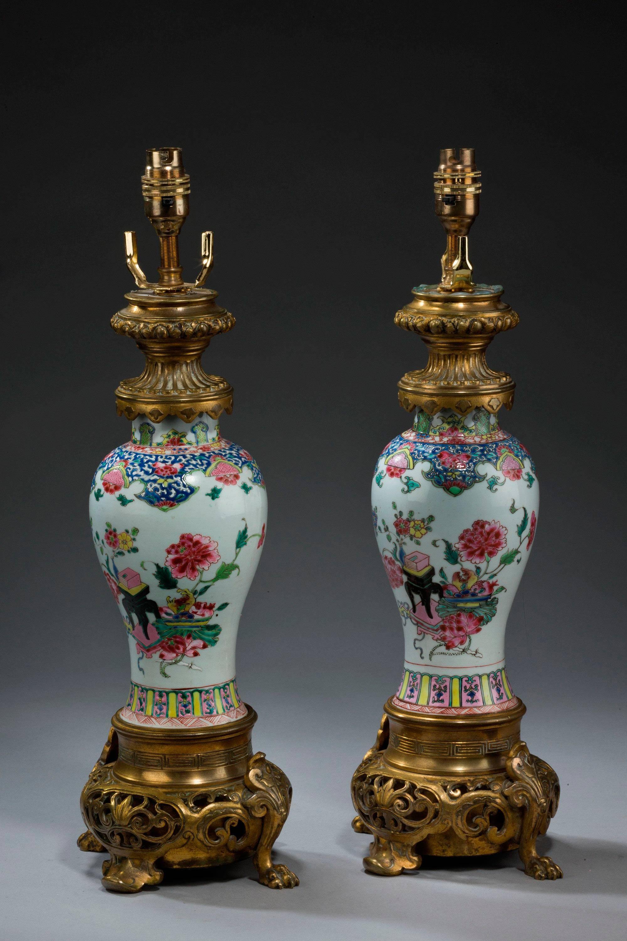 Pair of 19th century Canton porcelain vase lamps, with 18th century gilding. The ovoid bodies with oriental flowers decoration. Heavily cast bases.

Canton porcelains are Chinese ceramic wares made for export in the 18th-20th centuries. The wares