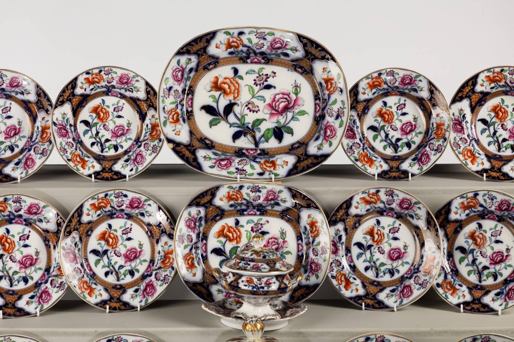 A most attractive mid-19th century Staffordshire part dinner service with very colourful flowers in reserve grounds. Blue frame work with finely gilded detail.

Measures: 4 x soup bowls. 
7 x 9 inch plates.
13 x 10 inch plates.
3 x platters.
1