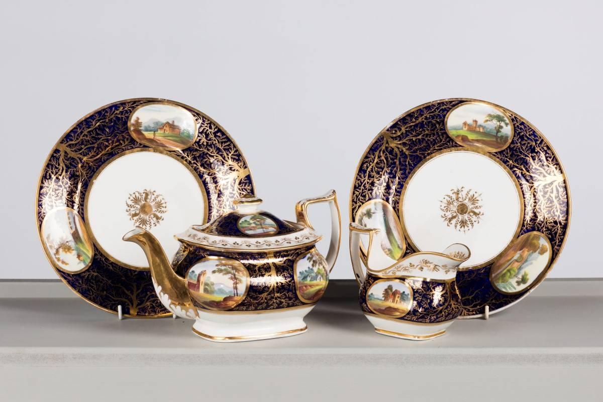 Early 19th century part tea service. The reserve panels with country scenes including bridges, rivers ect. The gilding of seaweed form.

1 x tea pot.
1 x sugar.
2 x plates.
4 x cups.
4 x saucers.
1 x oval dish.
1 x jug.
  