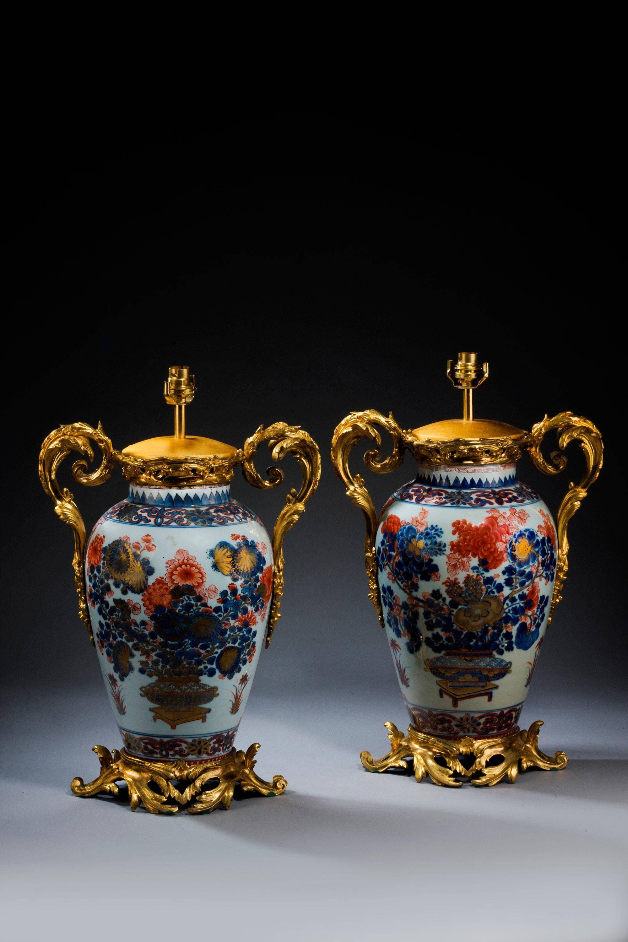 Exceptional pair of Samson of Paris 19th century oriental ovoid vase lamps of the finest quality in the 18th century oriental style. Finely chiseled gilt bronze Rococo handles and bases. 

Shades are not included in the price of our lamps. We do