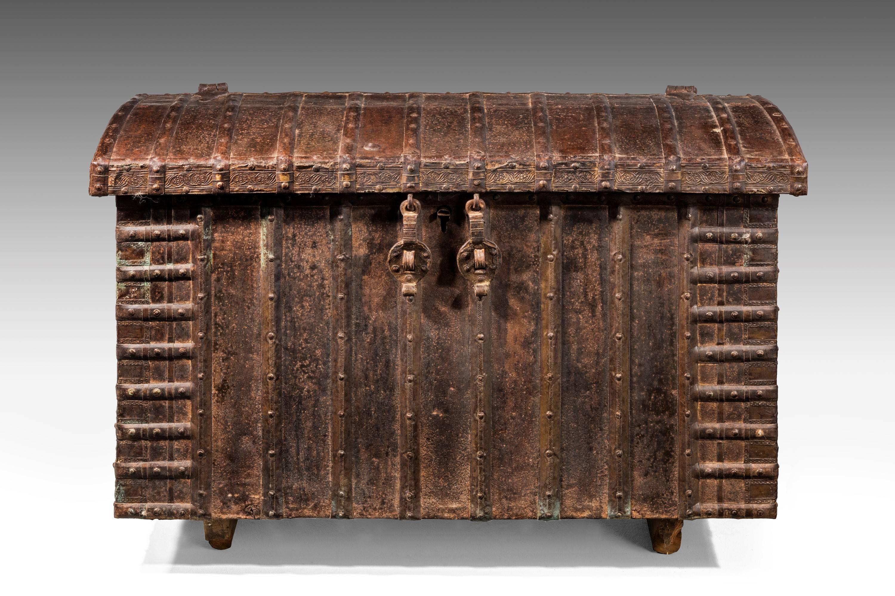 A good cast mid-19th century iron chest with strap-work detail. The slightly arched top over a ribbed lower section.