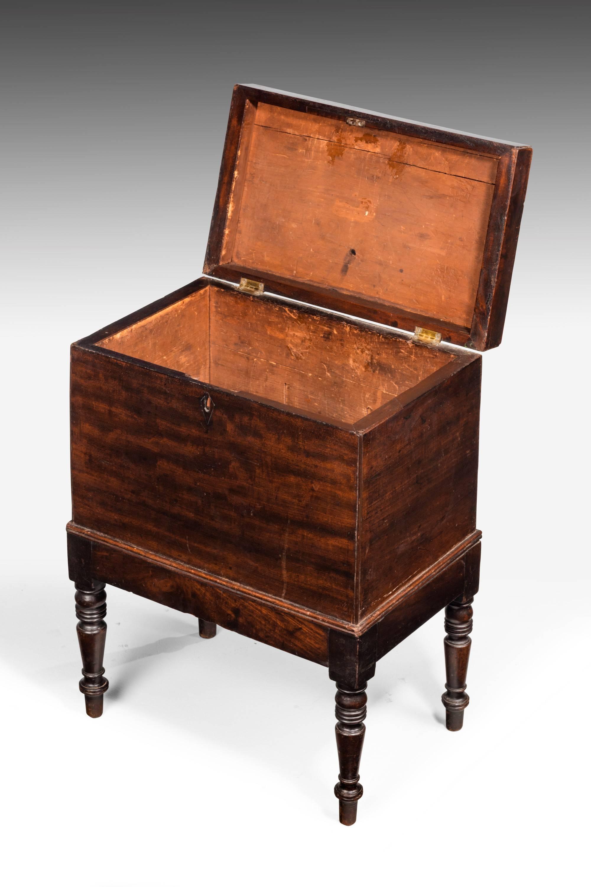 An usually small George III period mahogany cellaret. Raised on short turned supports. Good original overall color. The fitted interior now missing.
