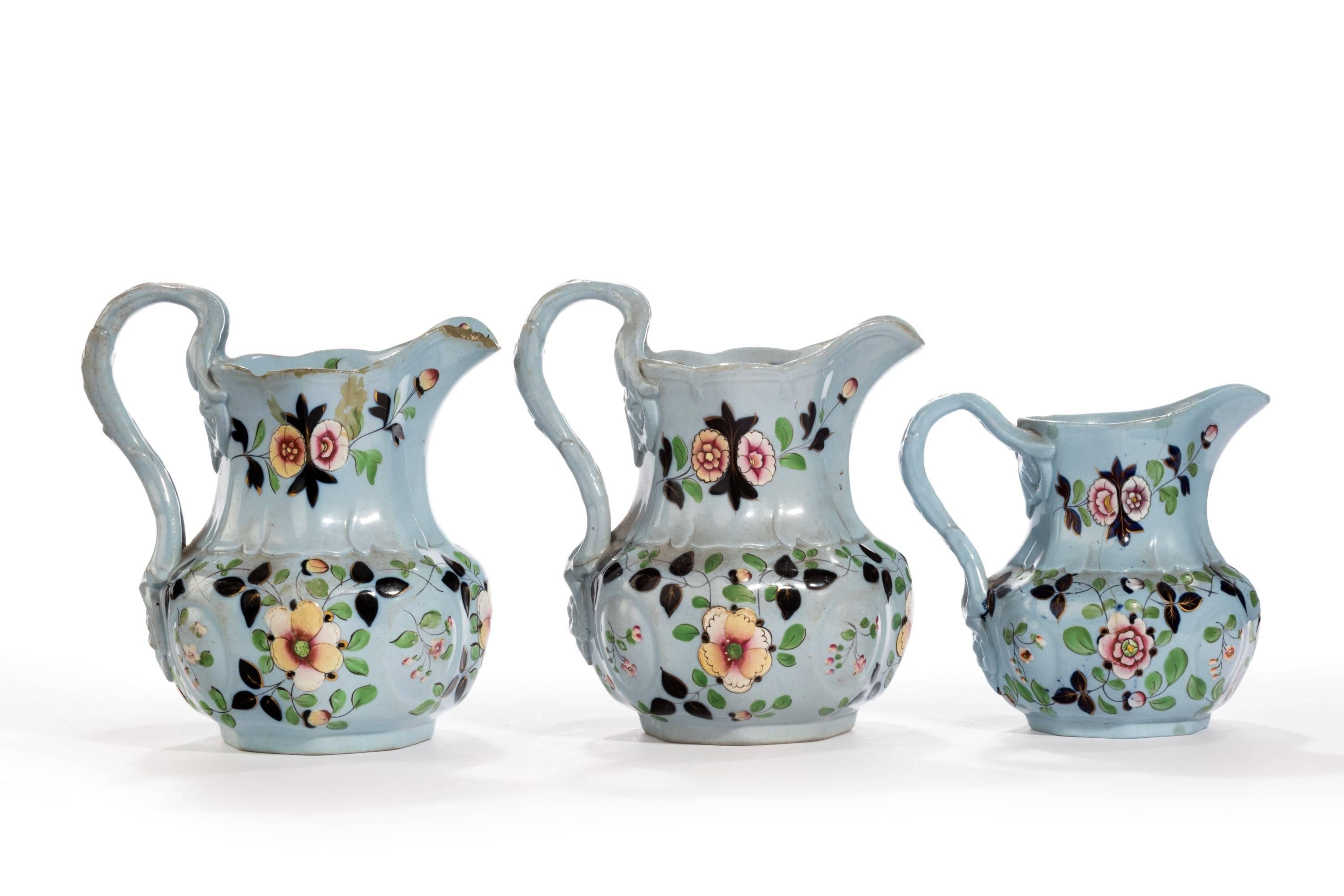 A Set of three graduated Victorian urban wear jugs almost certainly ridgeway. Attractively shaped bodies and complex handles. The larger jug with chips to the spout.