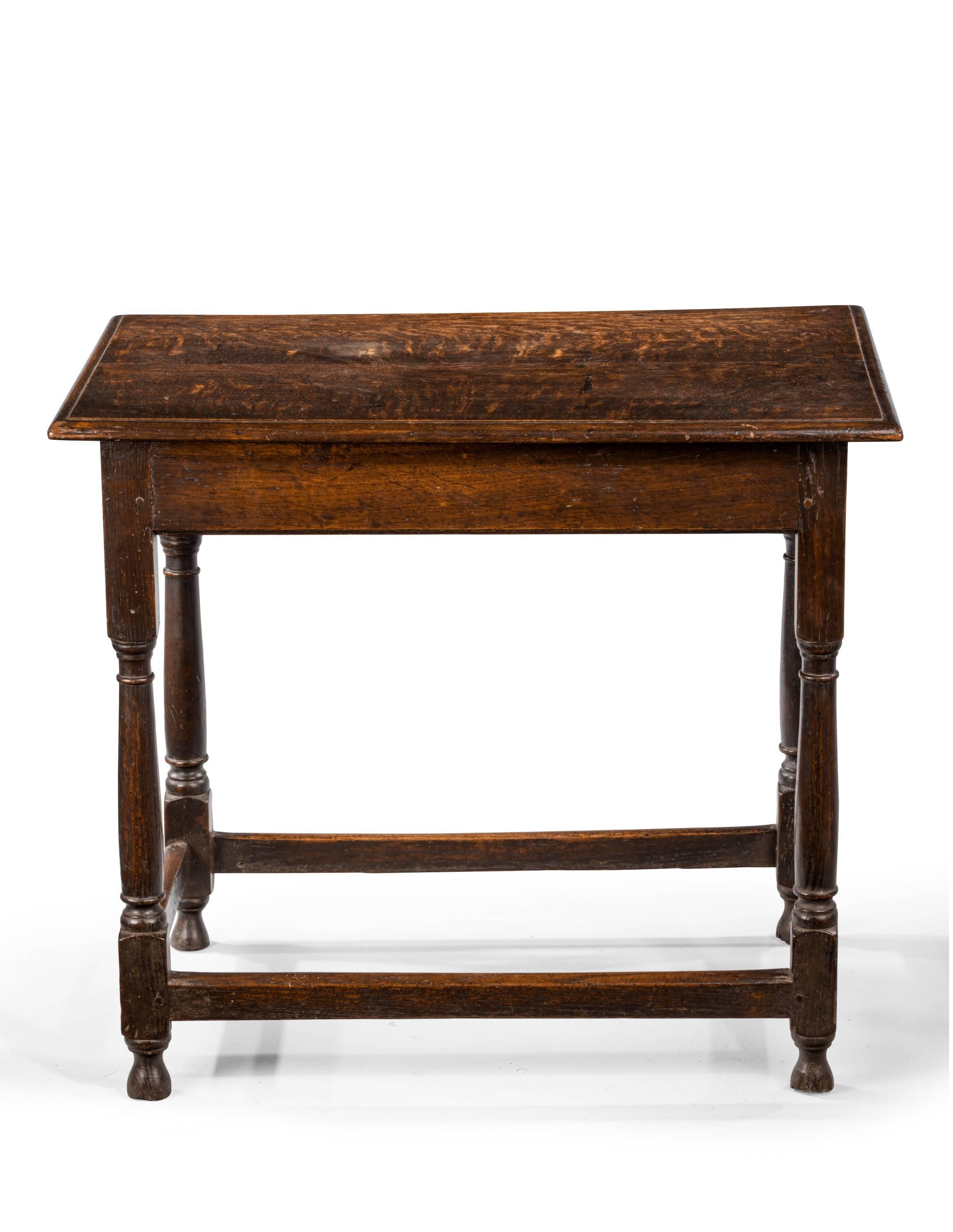 Mid-18th century side table. Rectangular top and a moulded edge. Raised on turned legs.