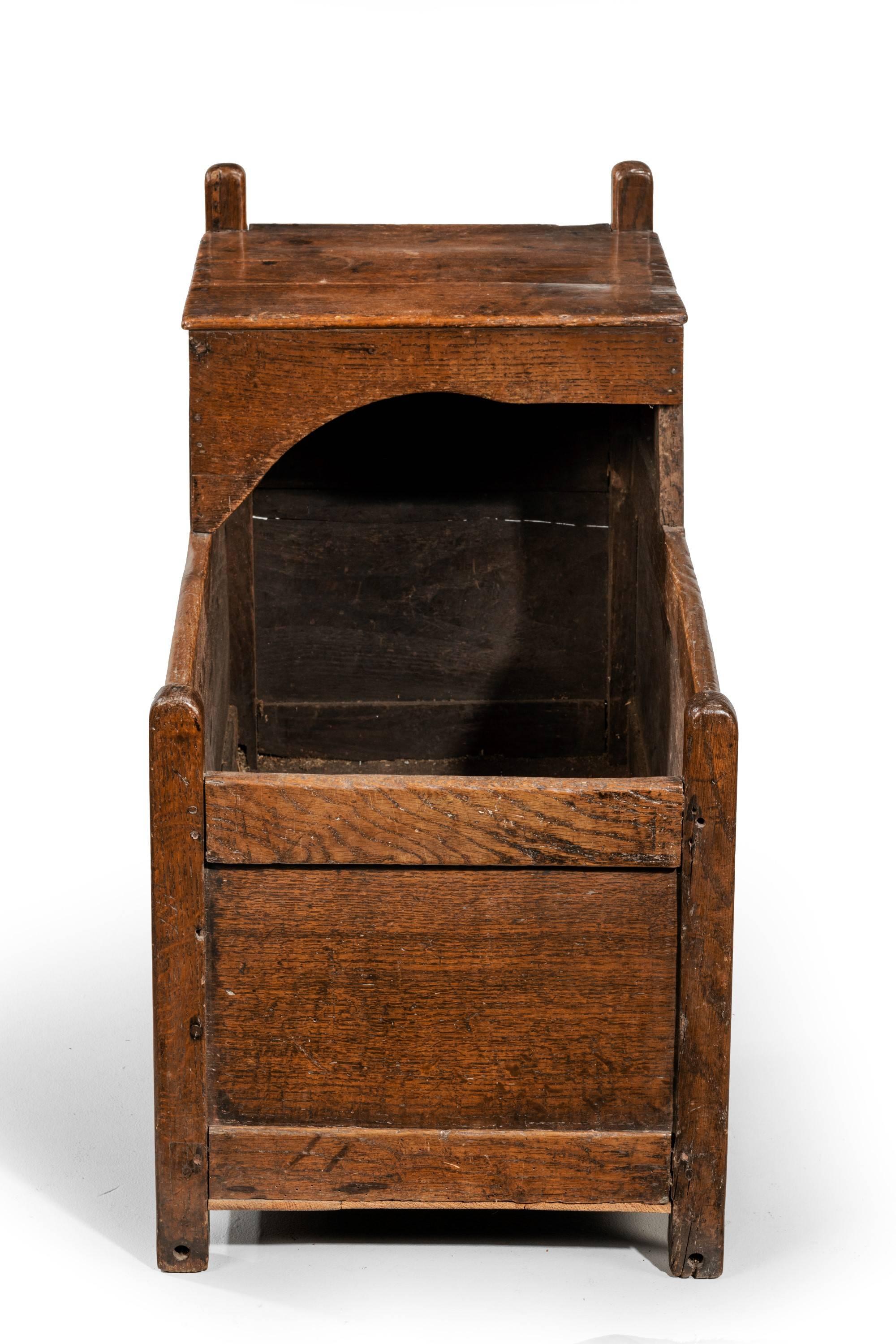 A mid-18th century oak crib. Strong construction with a hooded top section.