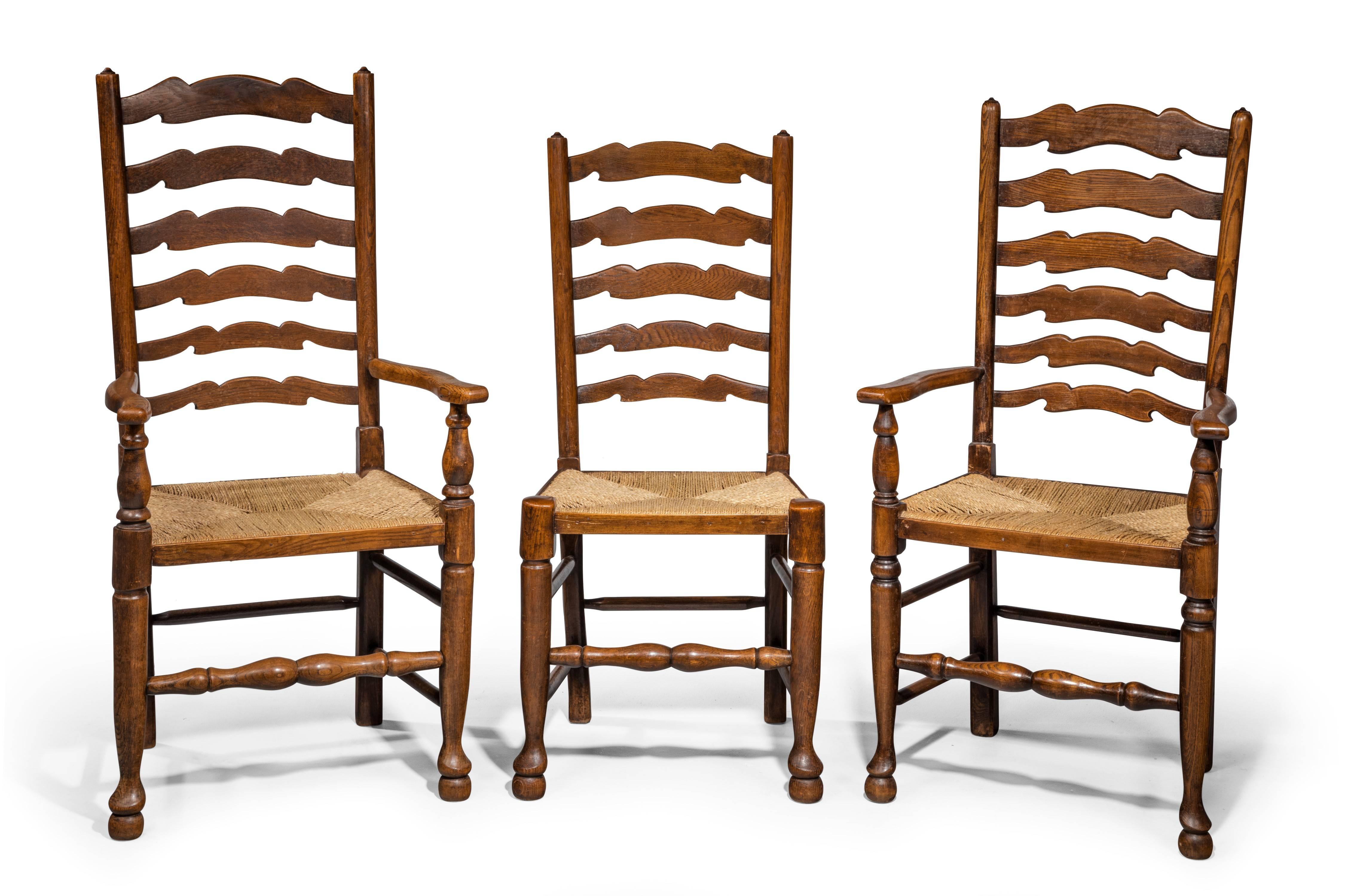 A good set of eight (six plus two) Lancashire oak ladderback chairs. Wavy top stretchers. Well turned sections to the base.

King:

Height 43.
Width 22.50.
Depth 20.

Queen:

Height 42.
Width 22.50.
Depth 18.