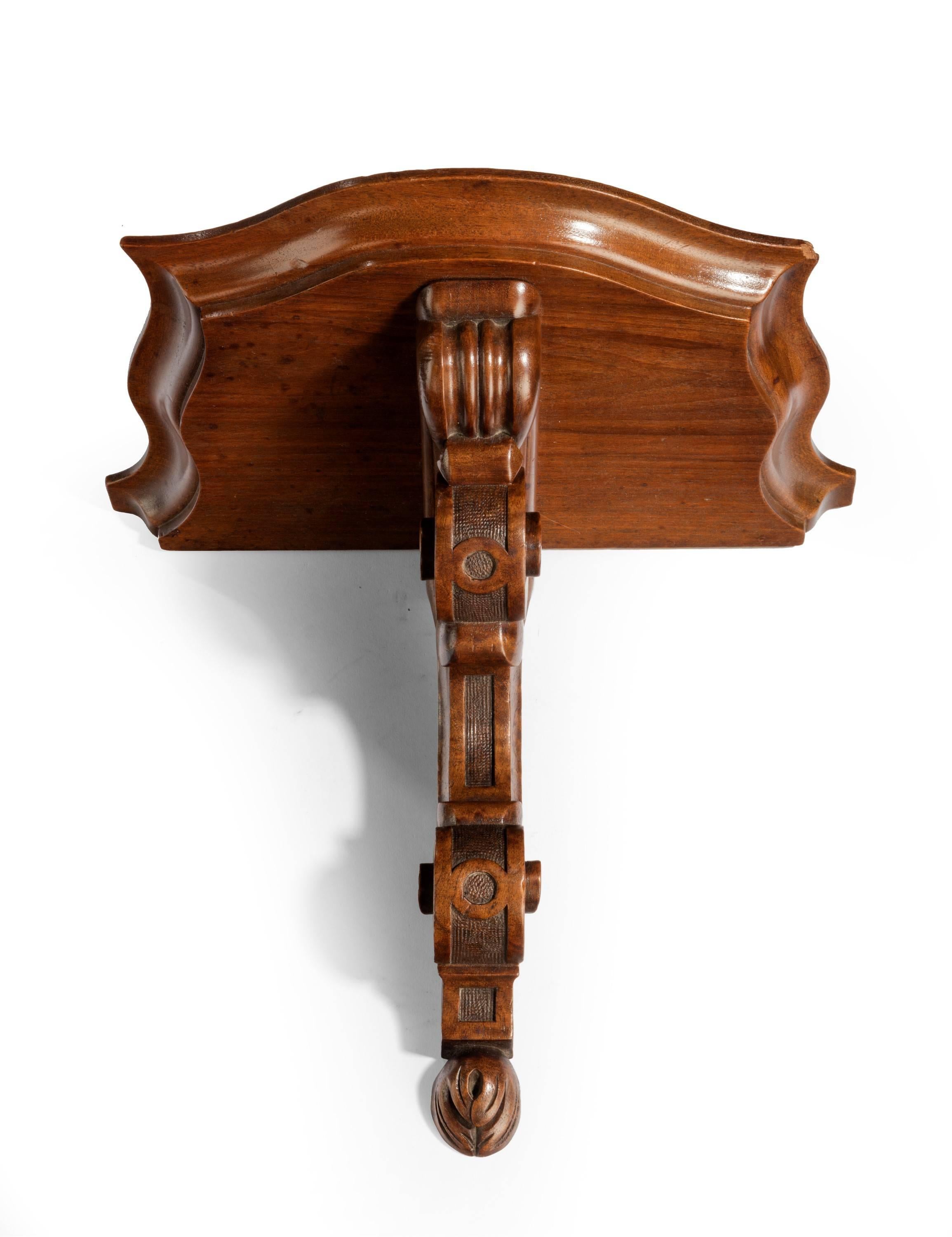 A well carved Victorian walnut bracket. Well shaped outline with a scroll support.