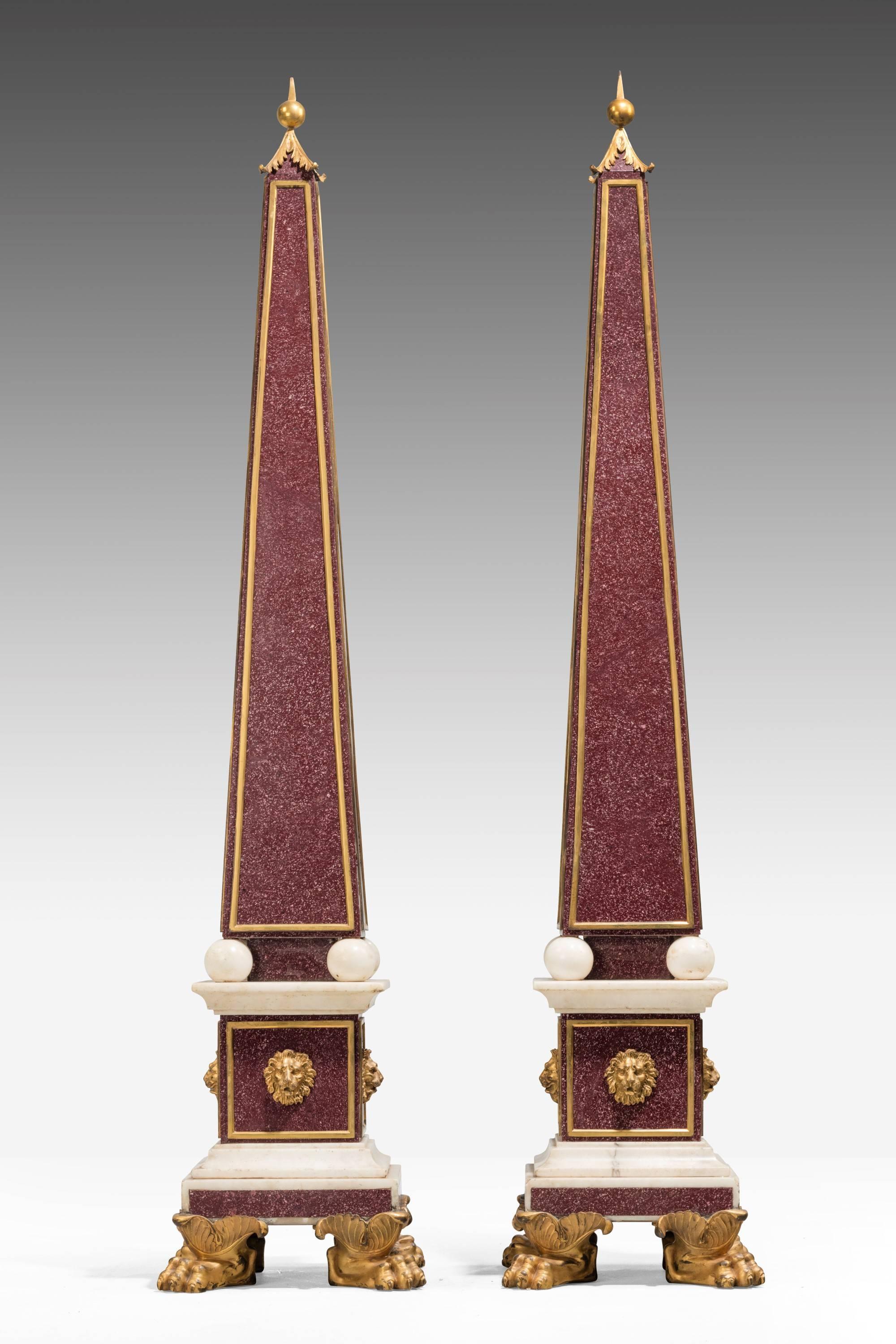 A highly important and impressive pair of late 19th century obelisks. Made of faux Porfiri Carrara marble and carved giltwood.