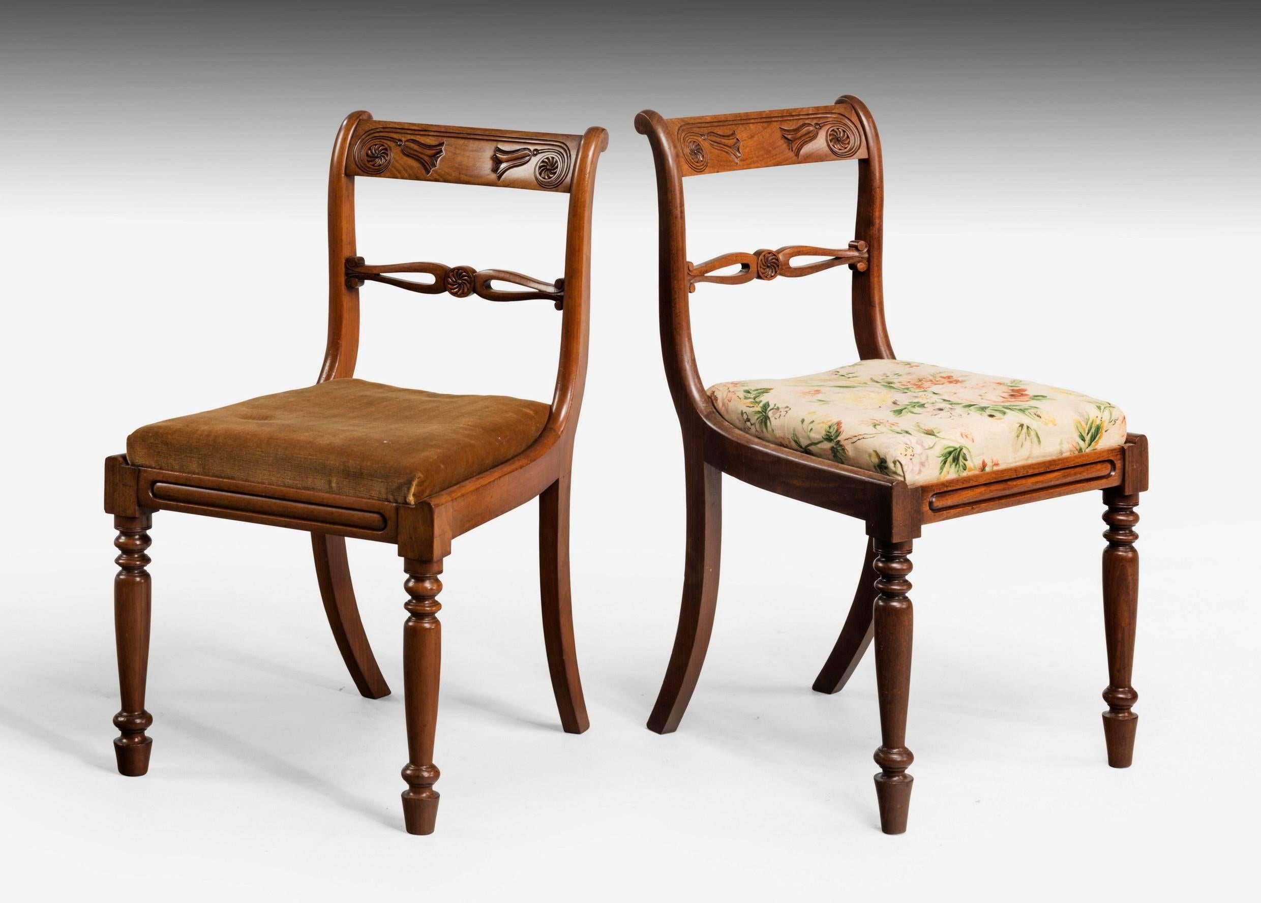 An attractive set of four late Regency period mahogany framed chairs. The back splats with whorls and hare bells. Turned tapering supports.

Measures: The smaller chairs:

Height 32.25 inches,
width 18 inches,
depth 16.50 inches.