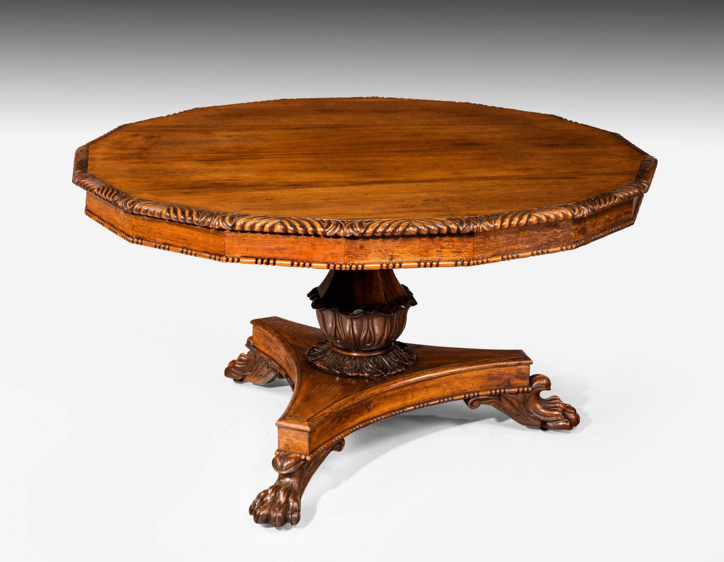 Regency period centre table with a finely carved edge. The top inset with sixteen sections. Very well constructed and executed shaped flared stork on a tri-form base. The feet of vigorously carved paw construction.