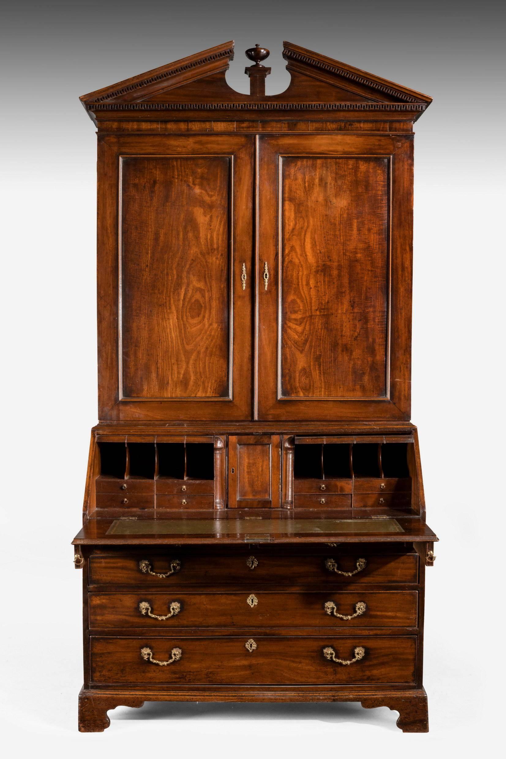 A fine quality and architecturally strong mahogany bureau bookcase. The interior with secret drawers involved in the friezes and complex construction. The top retaining the original broken arch pediment. Fine quality period gilt bronze handles