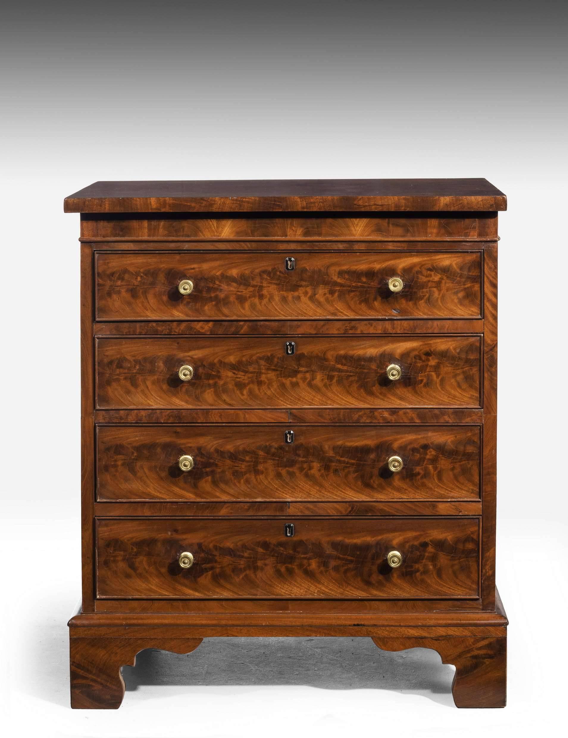 A beautifully figured small George III period lift top commode now converted to a four drawer chest. Exceptionally fine timbers. Period back shaped feet.