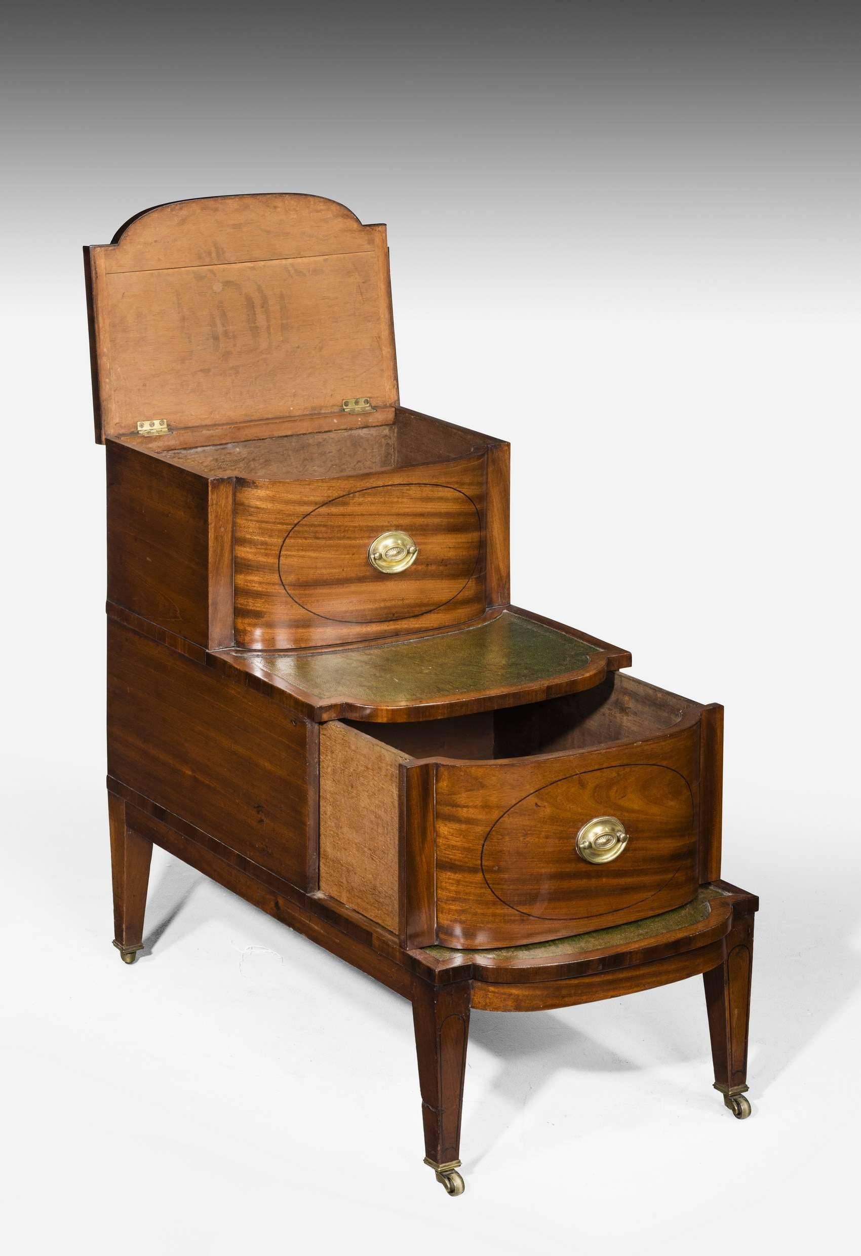 A good unusual set of Regency period mahogany library steps incorporating a commode. The very beautifully figured timber matching top to bottom over the three tiers. Original oval plate handles. The inset leather treads replaced some 30/40 years