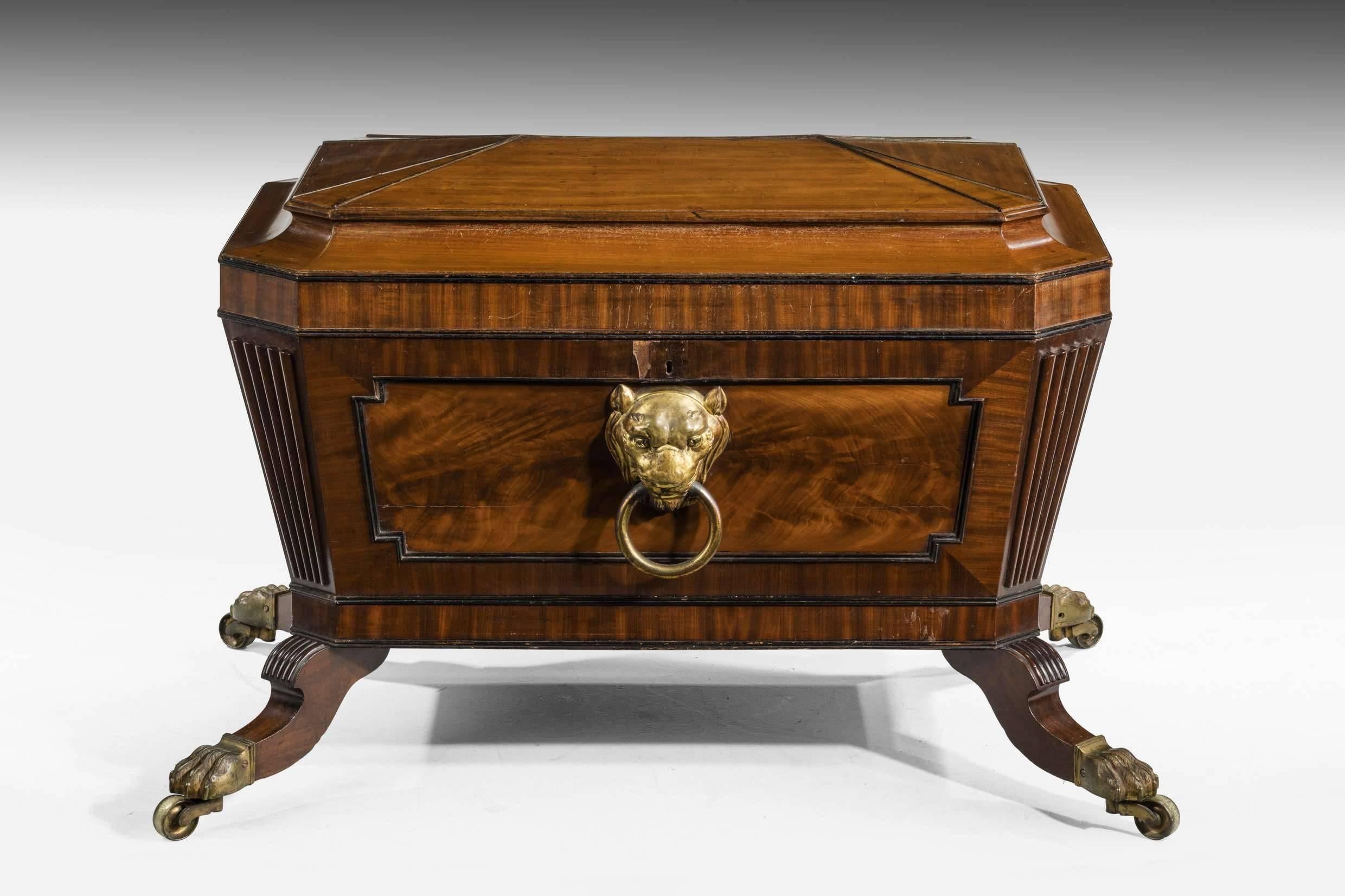 An important mahogany Regency period wine cooler with a shaped top. Cantered corners with reeded decoration on very strong shaped legs ending in original massive shoes and castors. Of the finest quality and no doubt made for an important house.