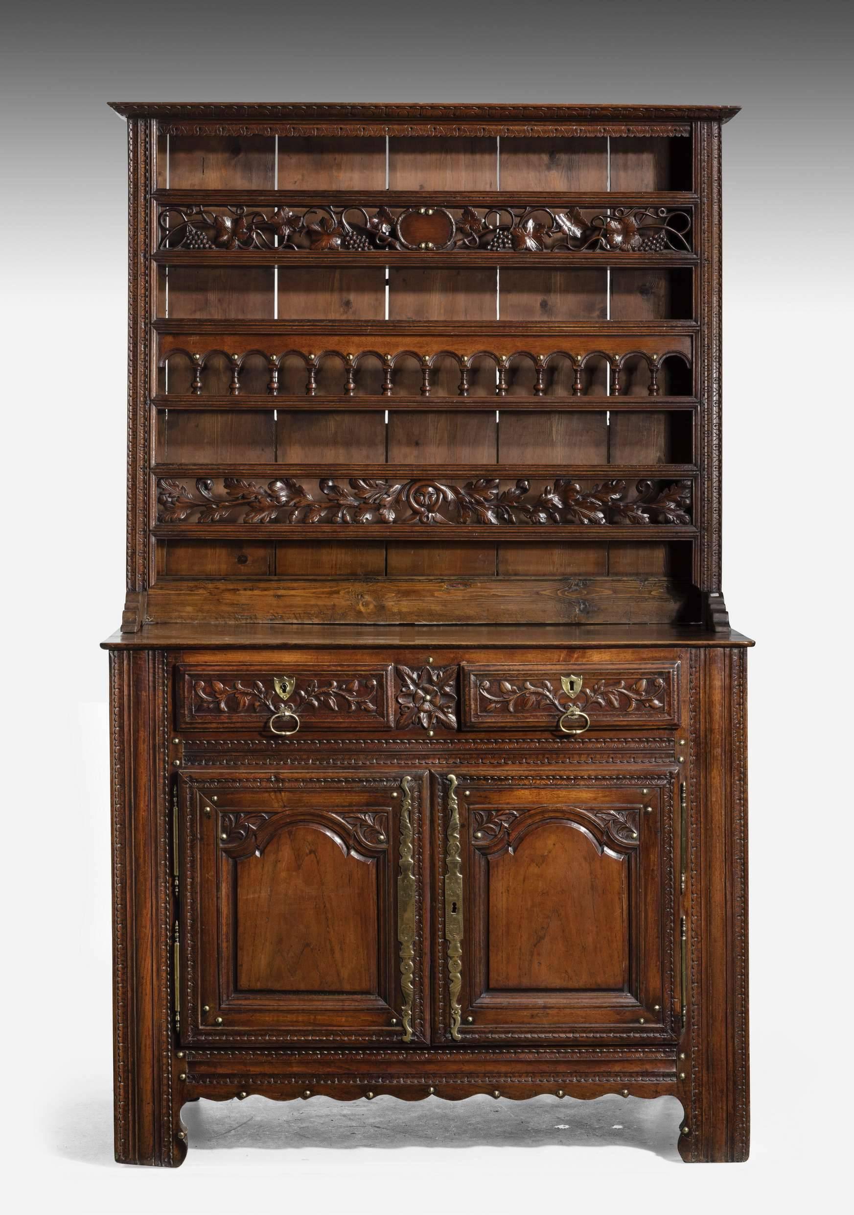 A splendid quality mahogany French chestnut dresser and rack of small proportions. The front pieces carved with scrolling leaf work. The top section with arcading oak leaves and vine and grapes. Wonderful condition.