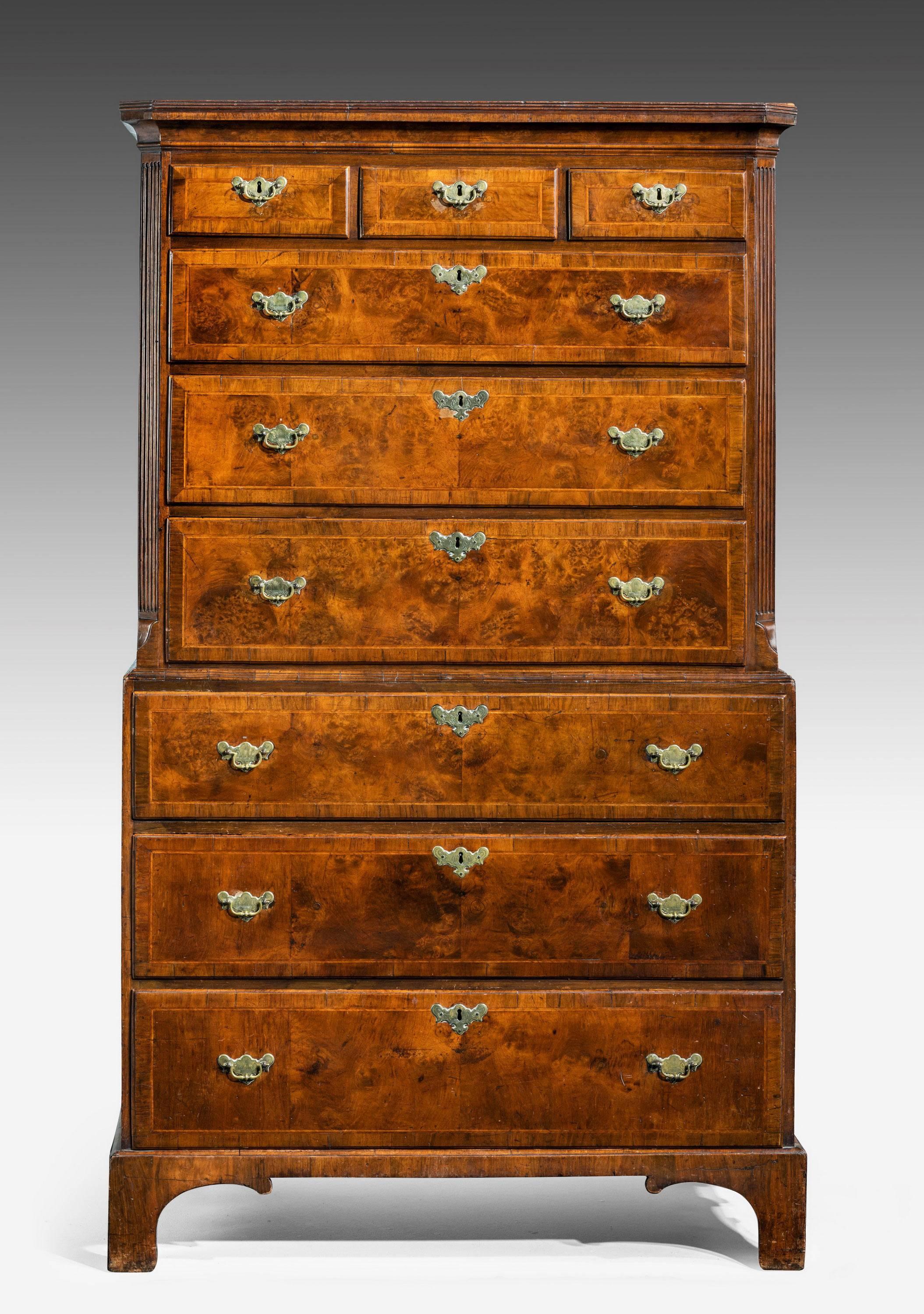 A George II period burr walnut feathered banned chest on chest. Well figured and matched timbers with crossbanded edges to all the drawers. Off set corners with reeded decoration. Original high bracket feet. From the estate of Fredrick William