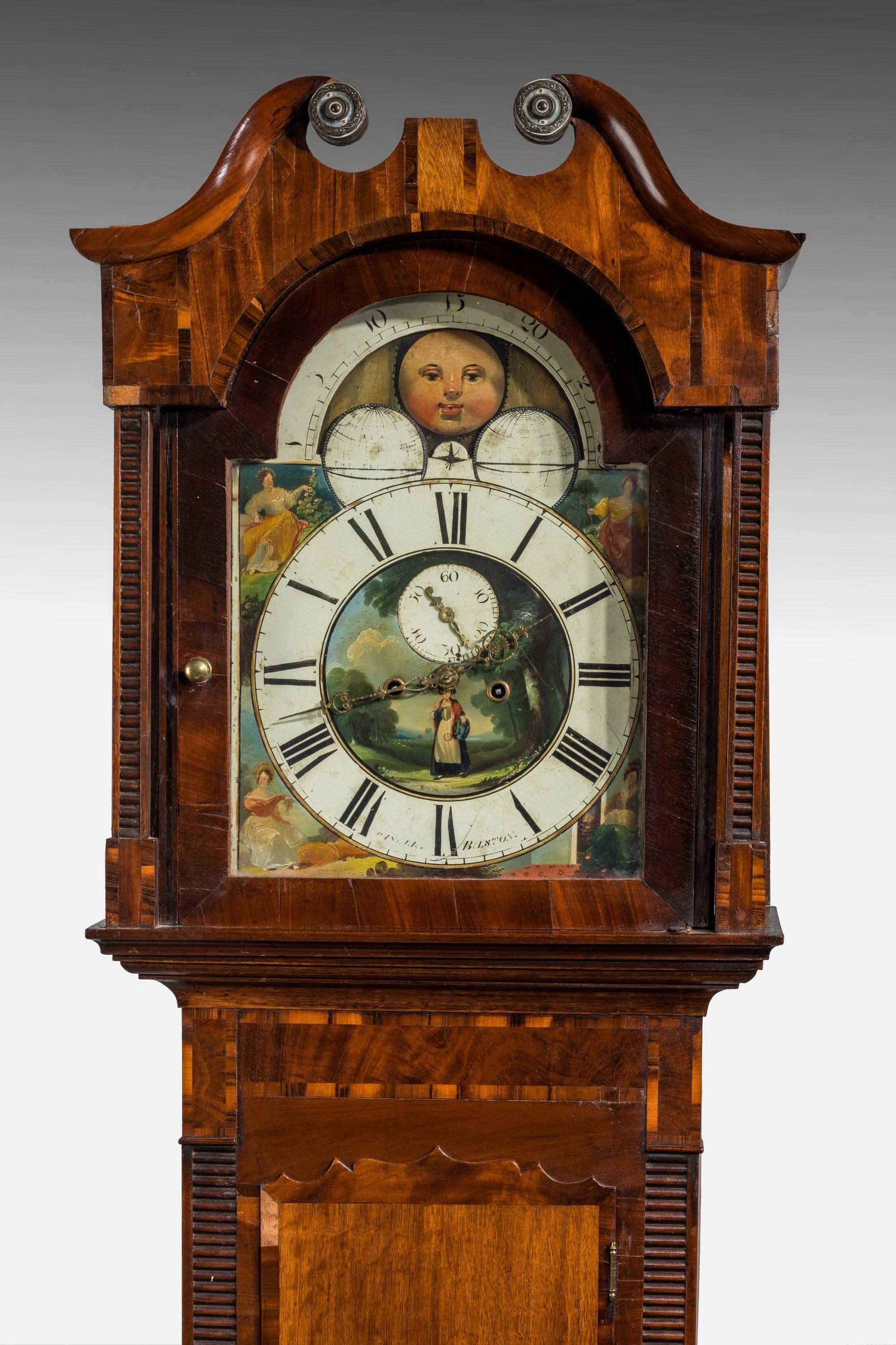 A early 19th century oak and mahogany longcase clock with arched movement incorporating a moon. Subsidiary second dial, indistinctly signed by Bilston maker. Original paint work. The case banded and crossbanded in contrasting timbers and on short