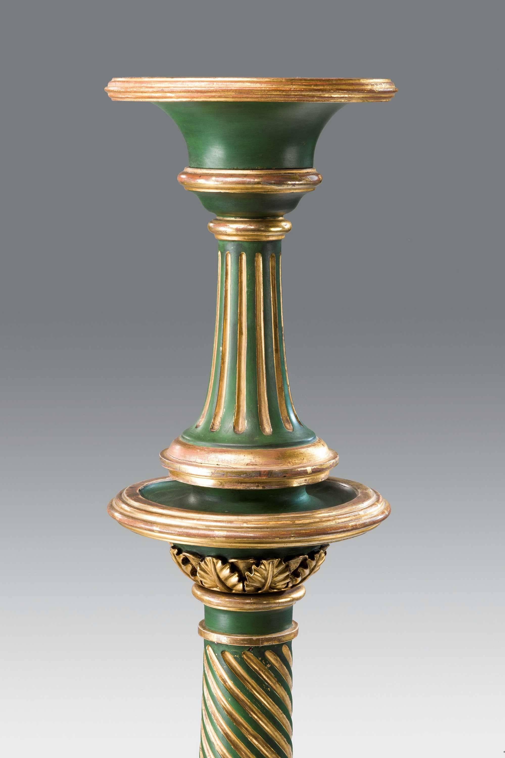 A fine pair of 19th century Regency period gilt and green decorated columns.
