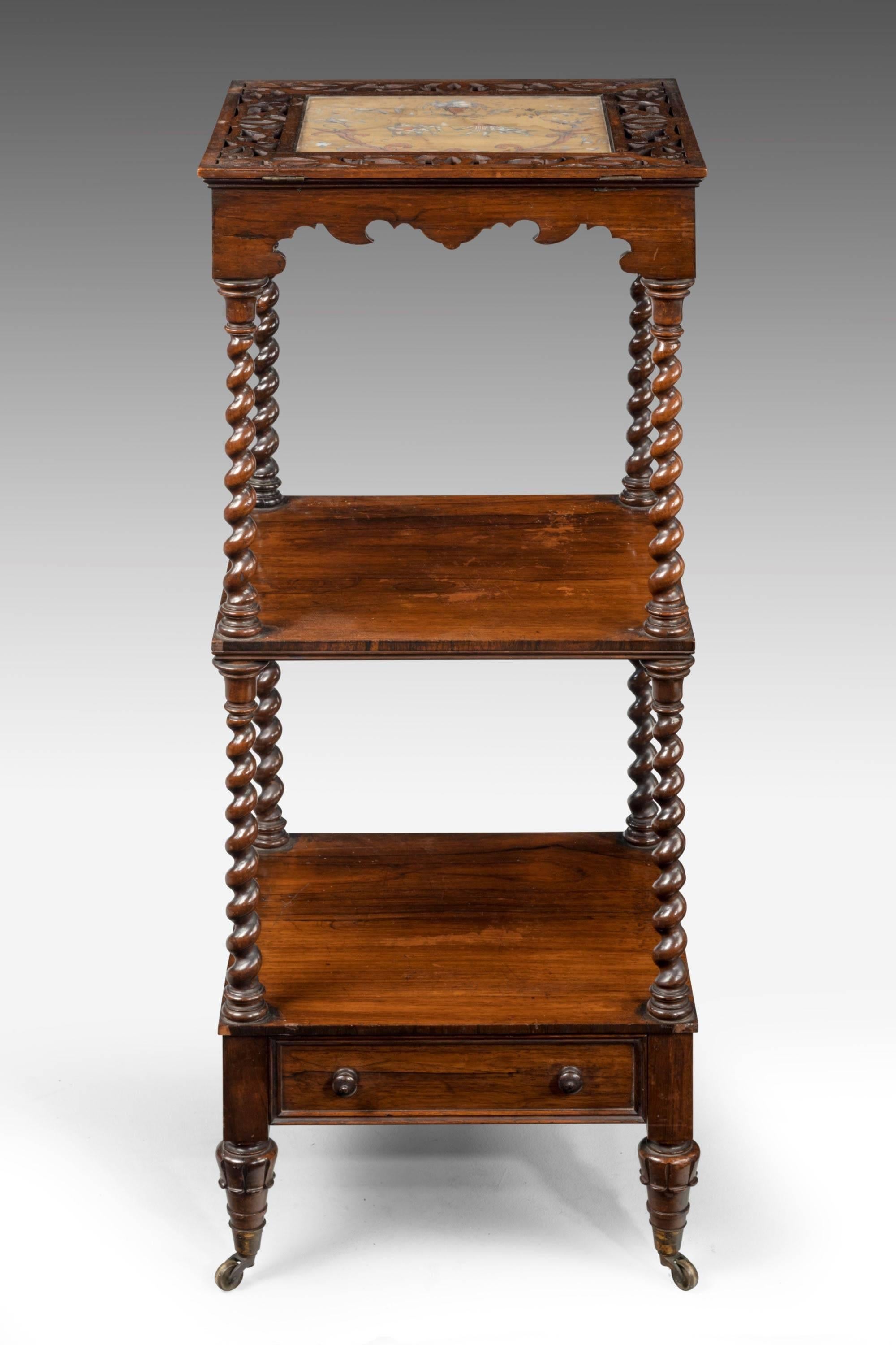 A most unusual 19th century  three tier whatnot. Finely turned baluster uprights. The top with an inset silk panel contained in a pierced border, on a ratchet for adjustment when reading. The base with a single drawer.
