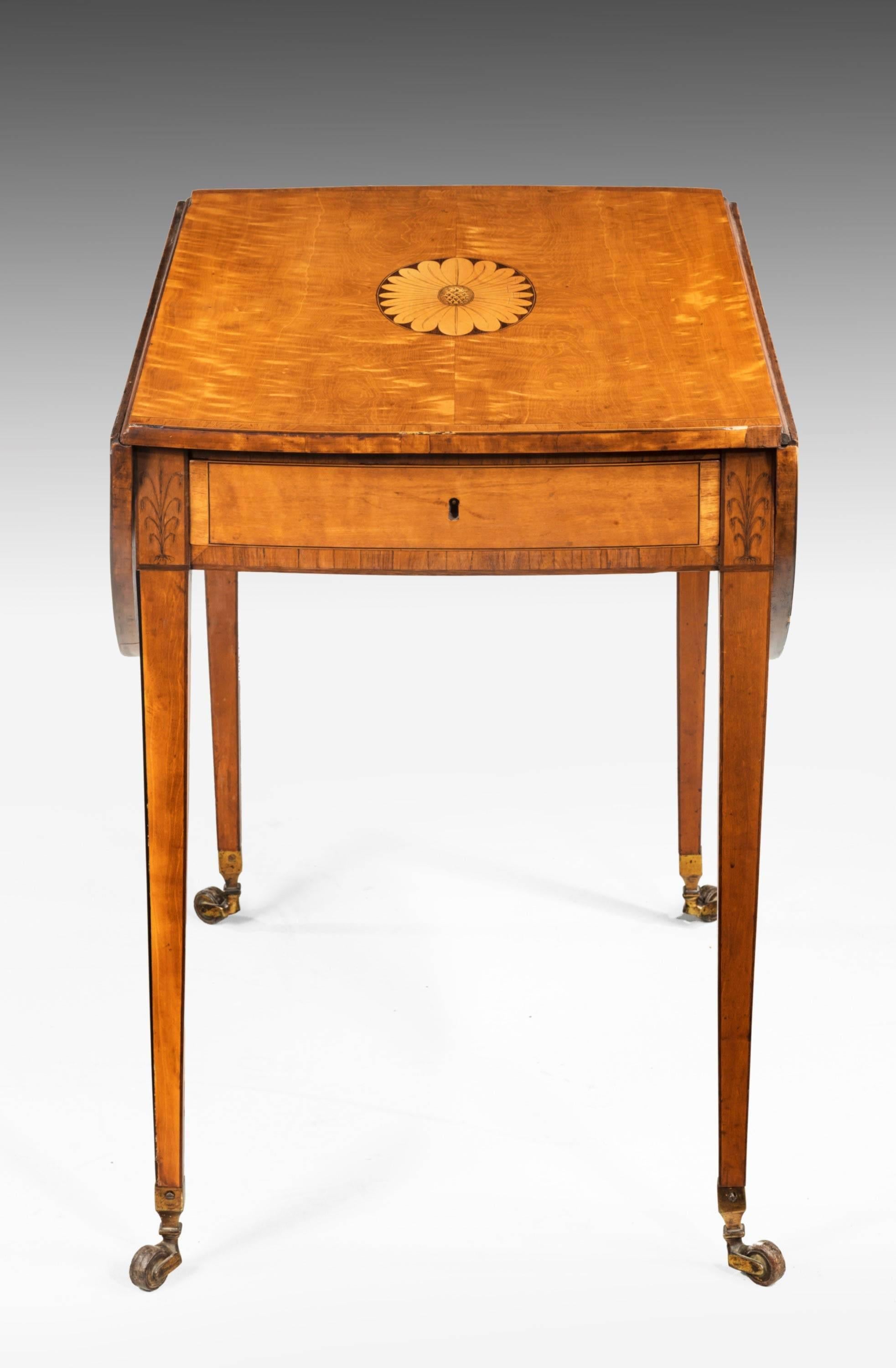 A fine quality late 18th century satinwood Pembroke table of oval form. The centre with large inlay contrasting timbers. Beautifully figured veneers in the oval construction. Tapering square supports with ebony edge inlay.

Width when open 40.50