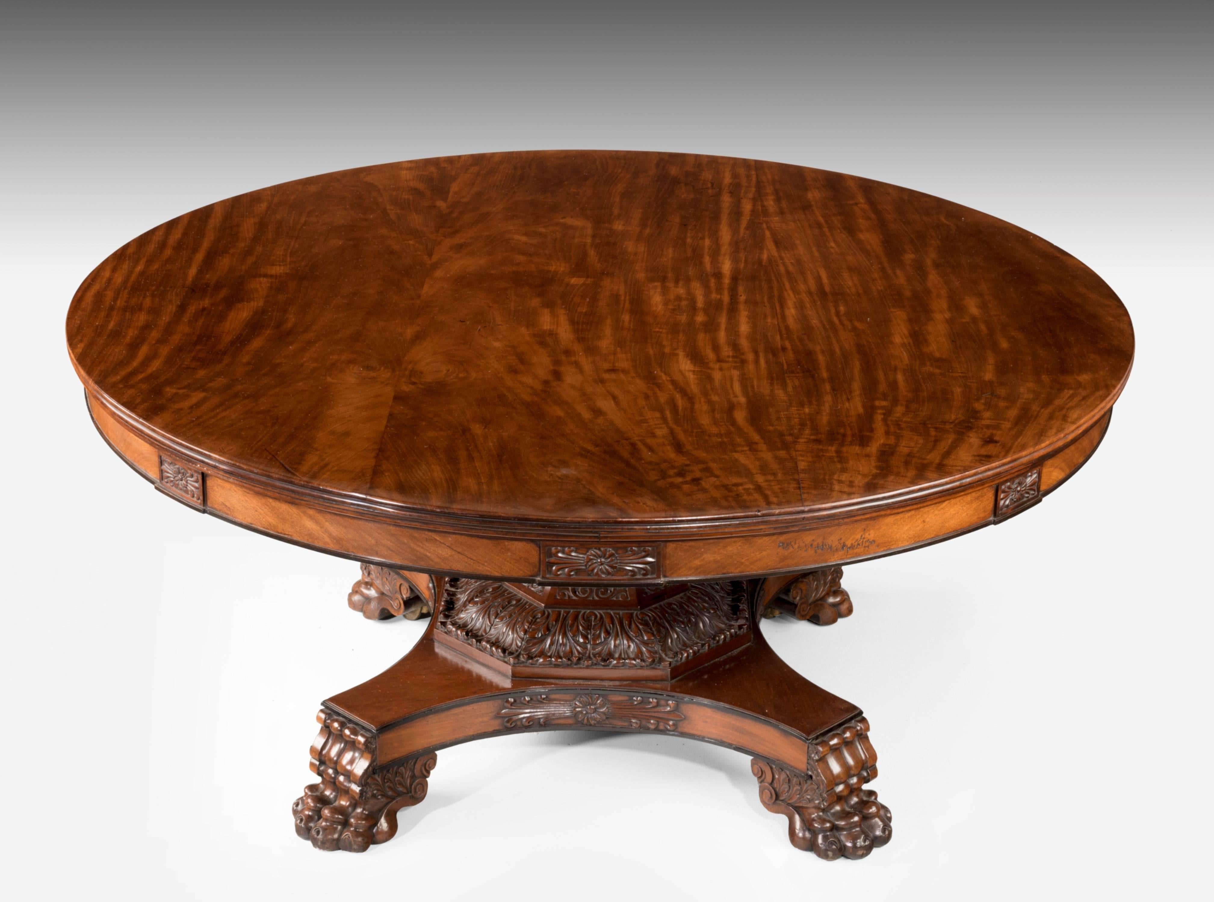 Quite outstanding Regency period mahogany large circular table. Extraordinary large size quite cable of seating 10 to 12 people. The base and centre section superbly carved in great depth with the finest quality mahogany. Typical of furniture coming