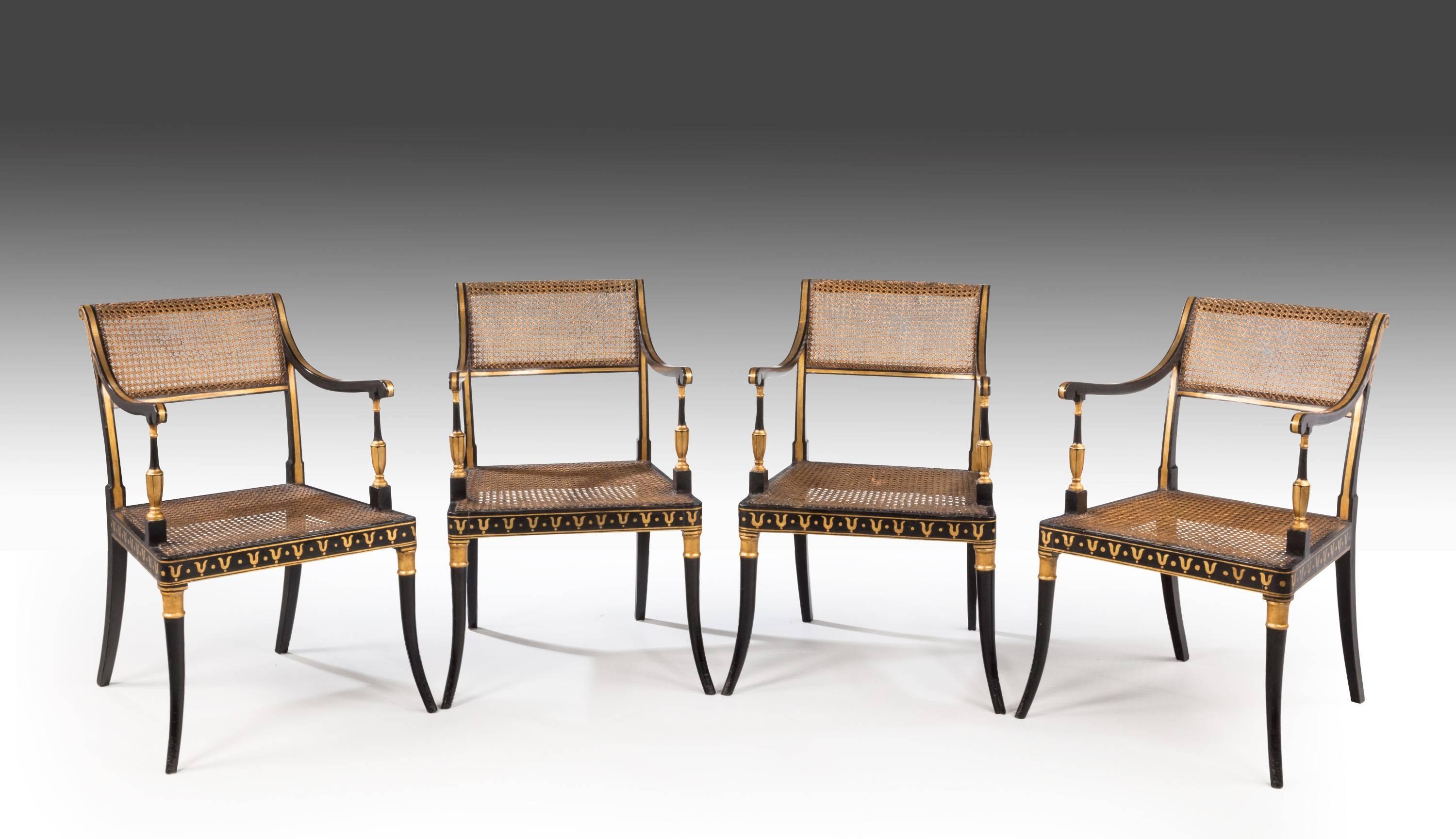 A very good set of four Regency period lacquered and parcel-gilt elbow chairs of fine line. Retaining the original canework. The gilding slightly restored particularly on the arms and the front bearer.

Measures: Seat height 19 inches.