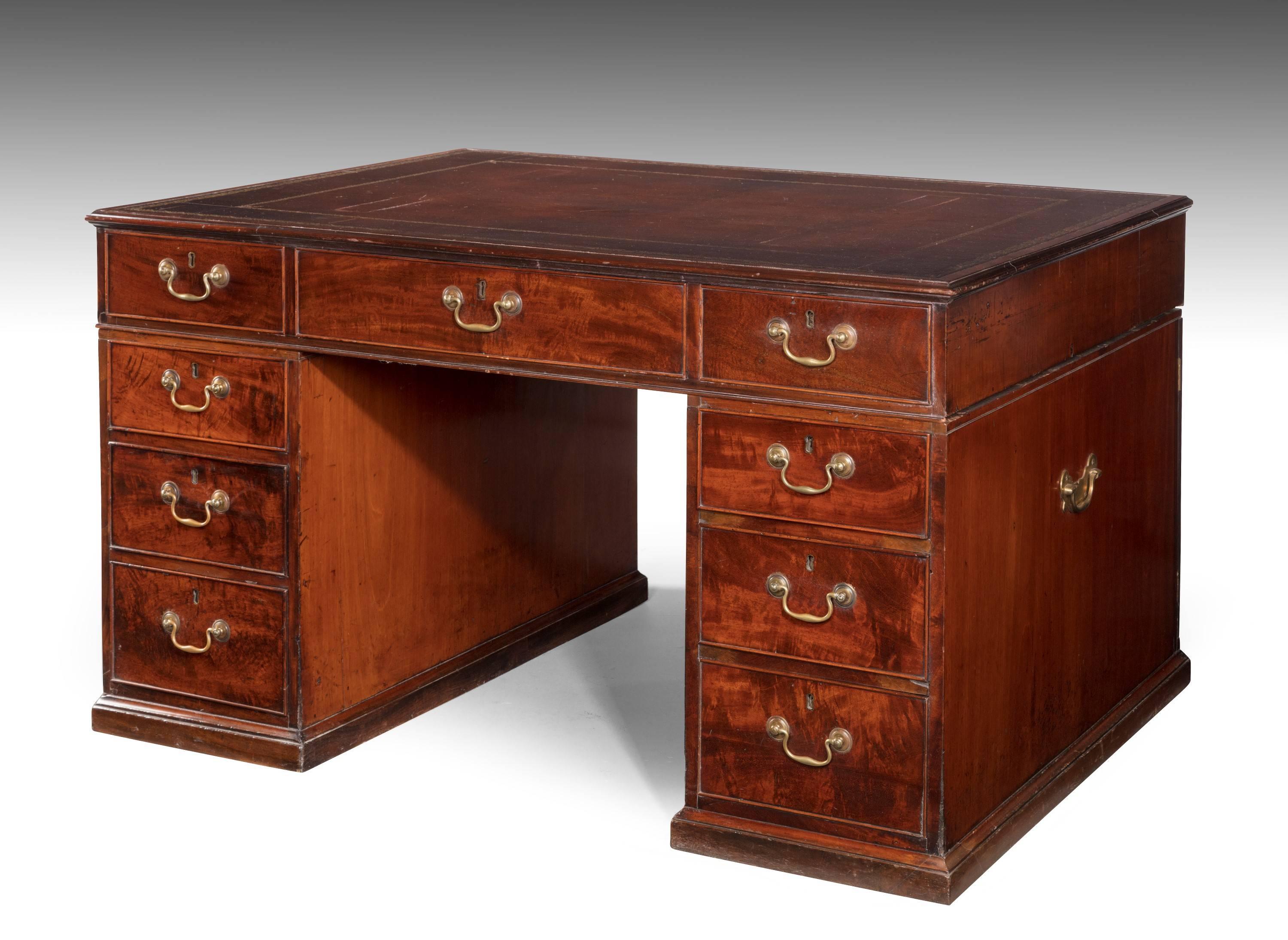 A very good George III period mahogany library desk of restrained form. One side with nine drawers the reverse with pedestal cupboards and three drawers to the top section. The best design of its type.