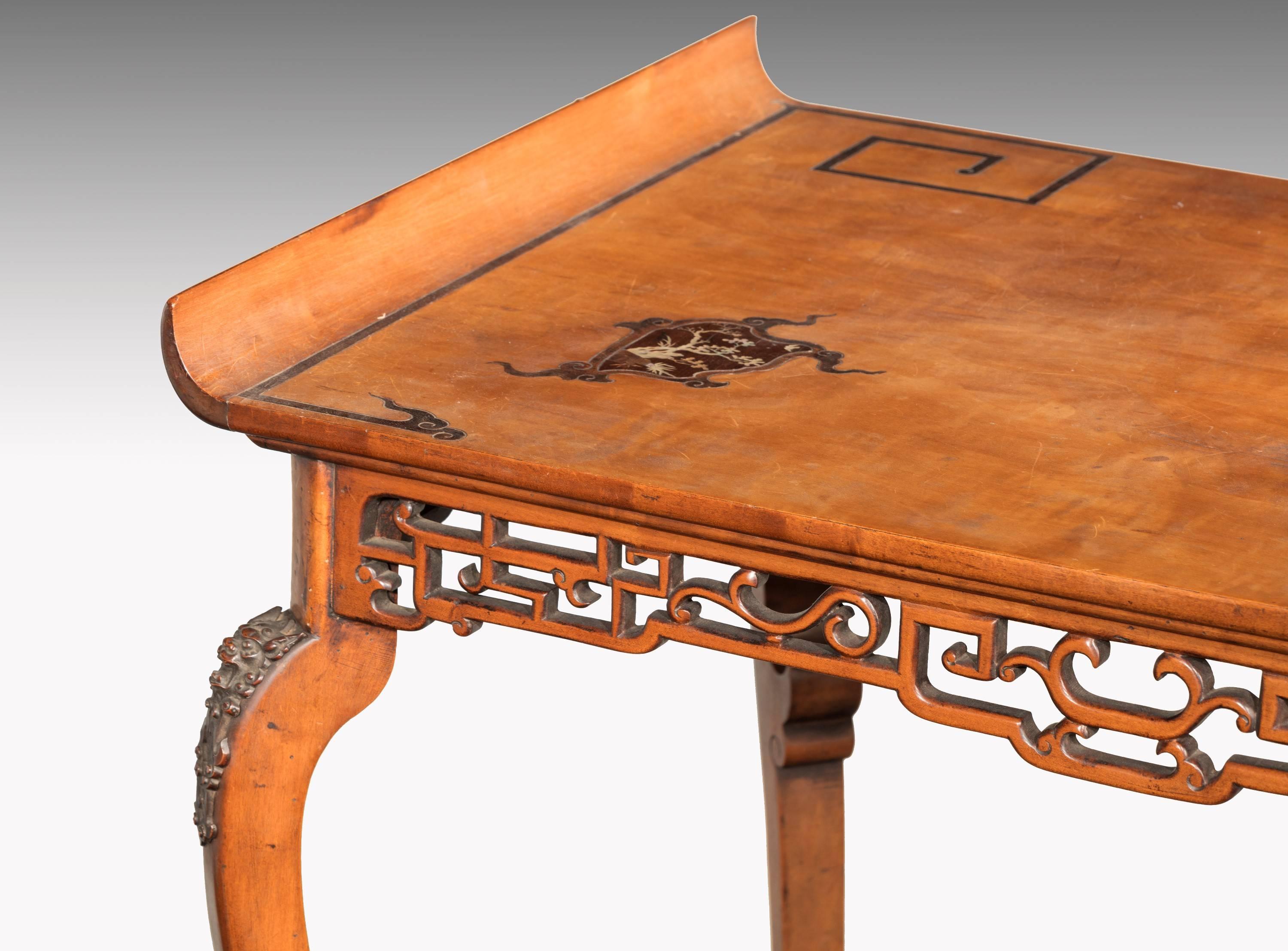 A most unusual Japonaise centre table on shaped cabriole supports ending in carved paw feet. The top with panels of inlaid Abalone pearl and contrasting timbers.
