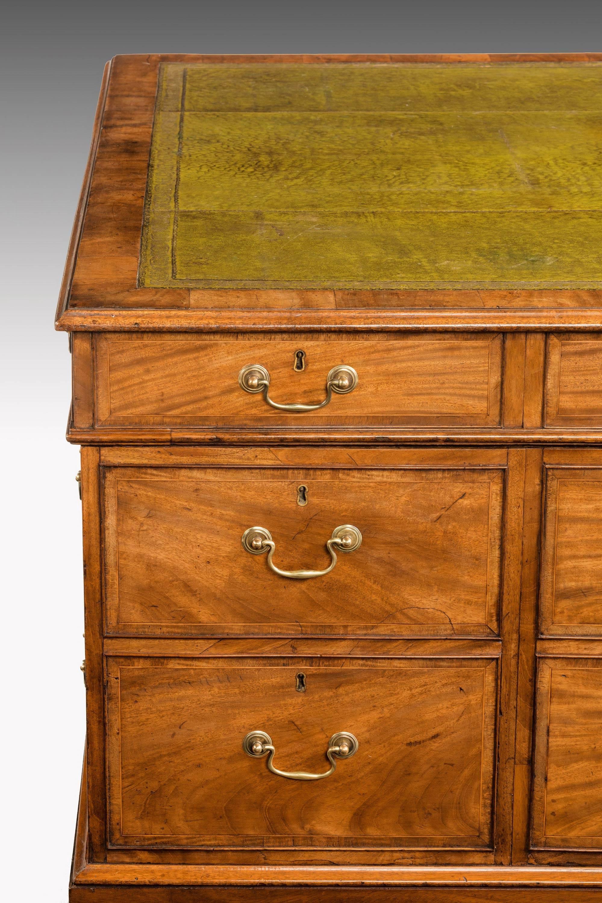 A very fine quality and restrained Chippendale period mahogany partners desk in three sections. The top with old, but replaced leather. Fine original swan neck handles. The whole of exceptional cabinet work and wonderful condition.

