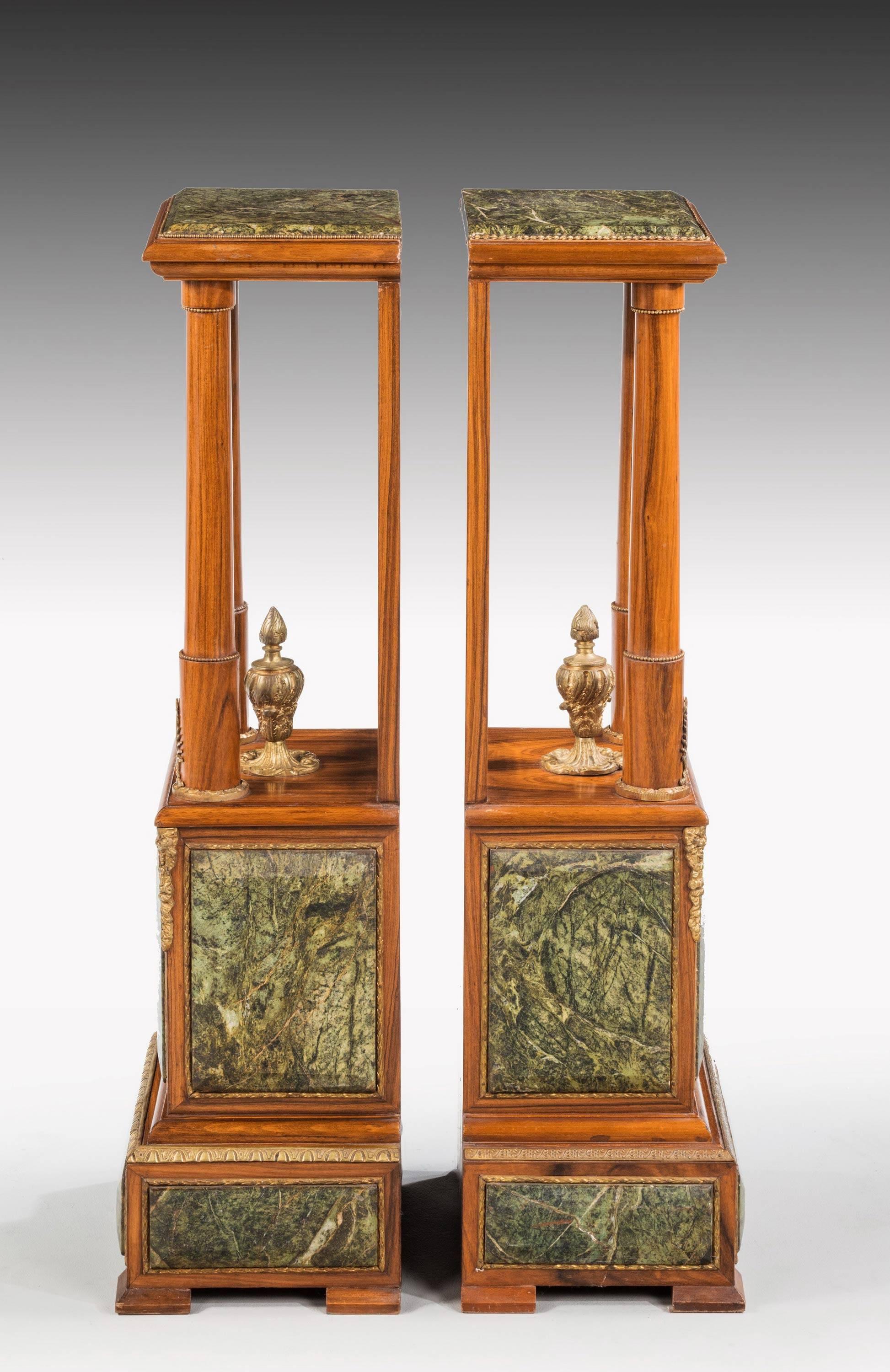 A most unusual pair of Louis XVI style hardwood and serpentine marble mounted stands. Complex construction. With good original gilt bronze mounts. 

N.