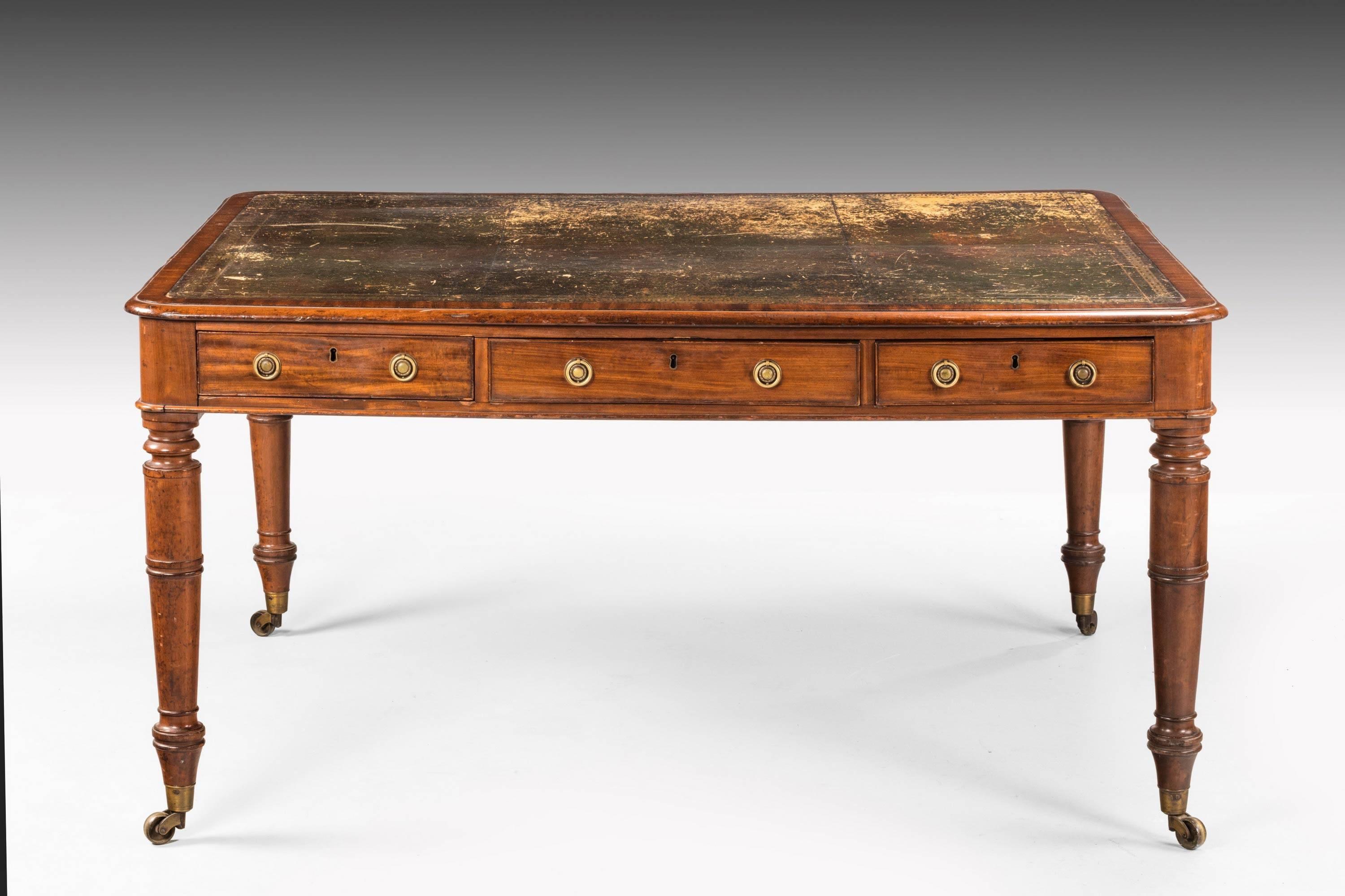 Late Regency period mahogany six-drawer library table. On well-turned supports terminating in the original shoes and castors. Good overall color. The top now worn but in excellent condition. 

N.