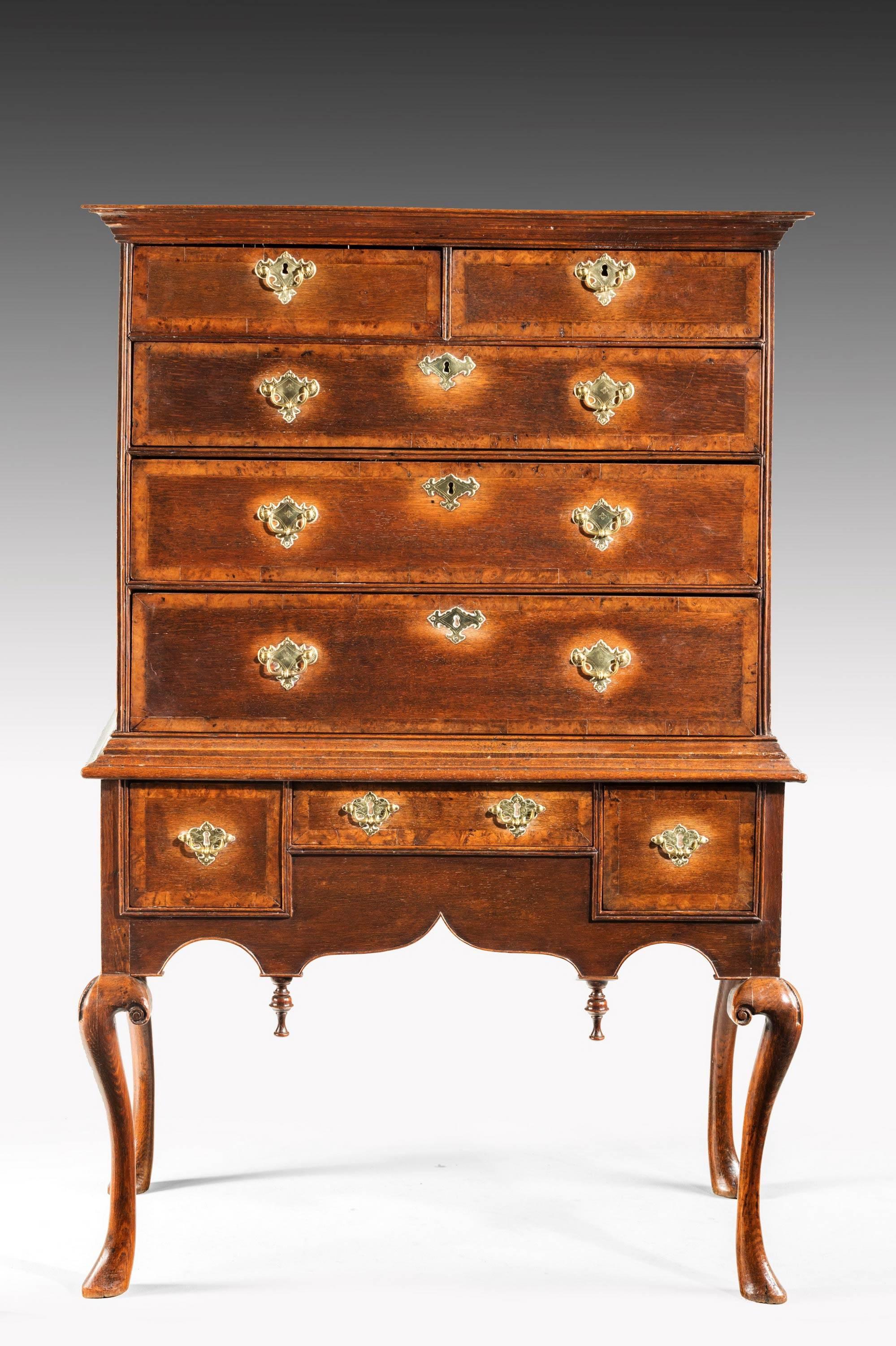 A most unusual and elegant mid-18th century oak tallboy or chest on chest. The drawers broadly banded in a burr timber. On high, finely carved, cabriole supports. Excellent color and patina.

