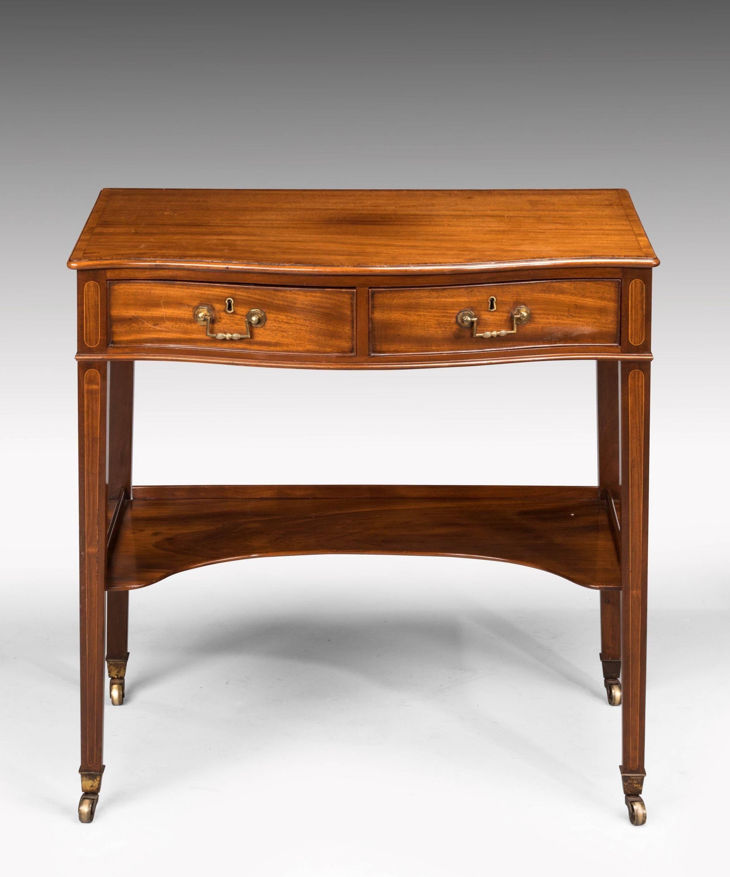 An elegant and well-made George III period mahogany side table, of very small proportions. The serpentine front incorporating two drawers, with very good original period square section handles. The underneath with a shaped tray. Square tapering