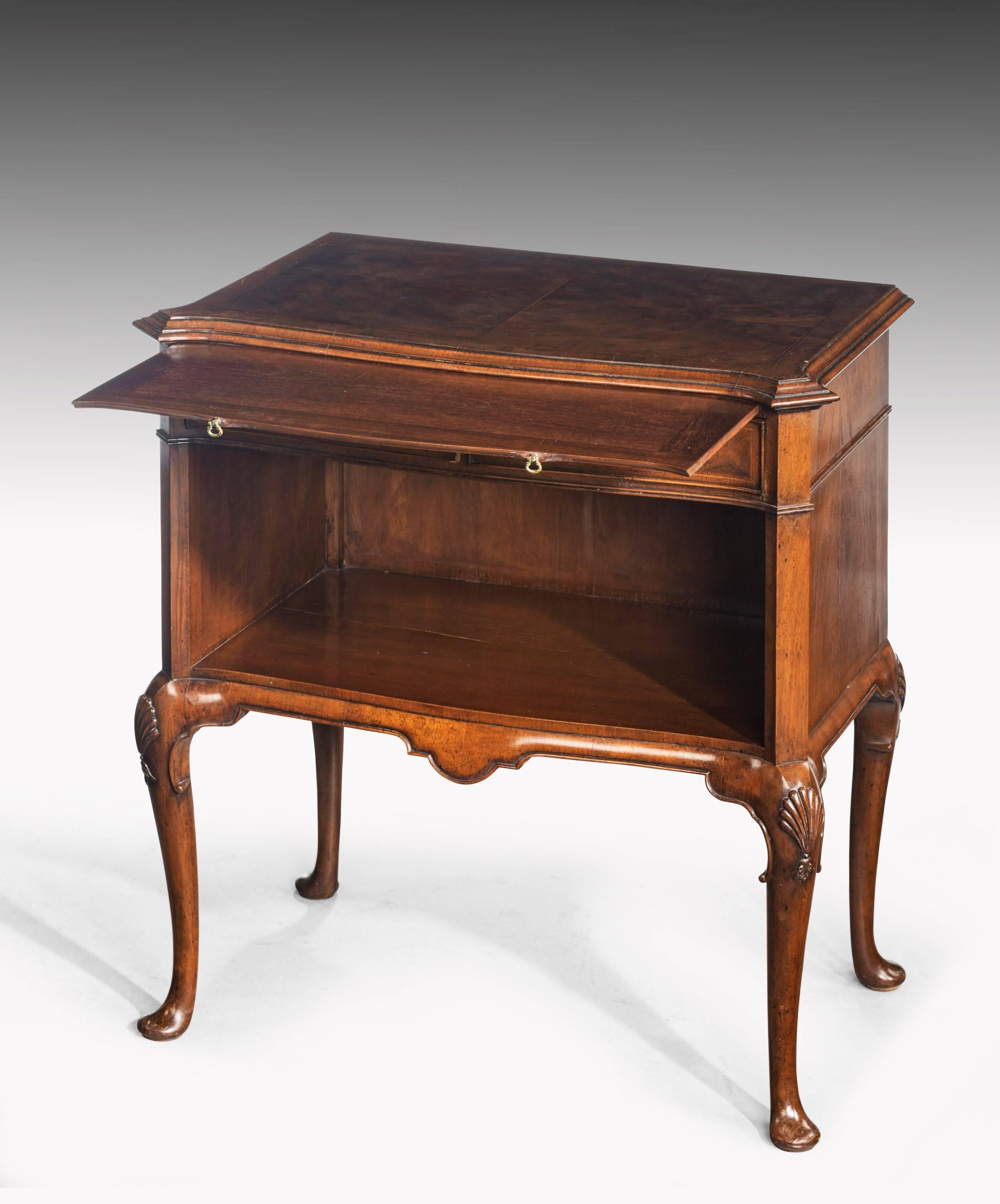 A very well made late 20th century mahogany night table incorporating an open book space and a drawer to the top section. With a quartered top over a serpentine front. Well carved cabriole supports. 

 