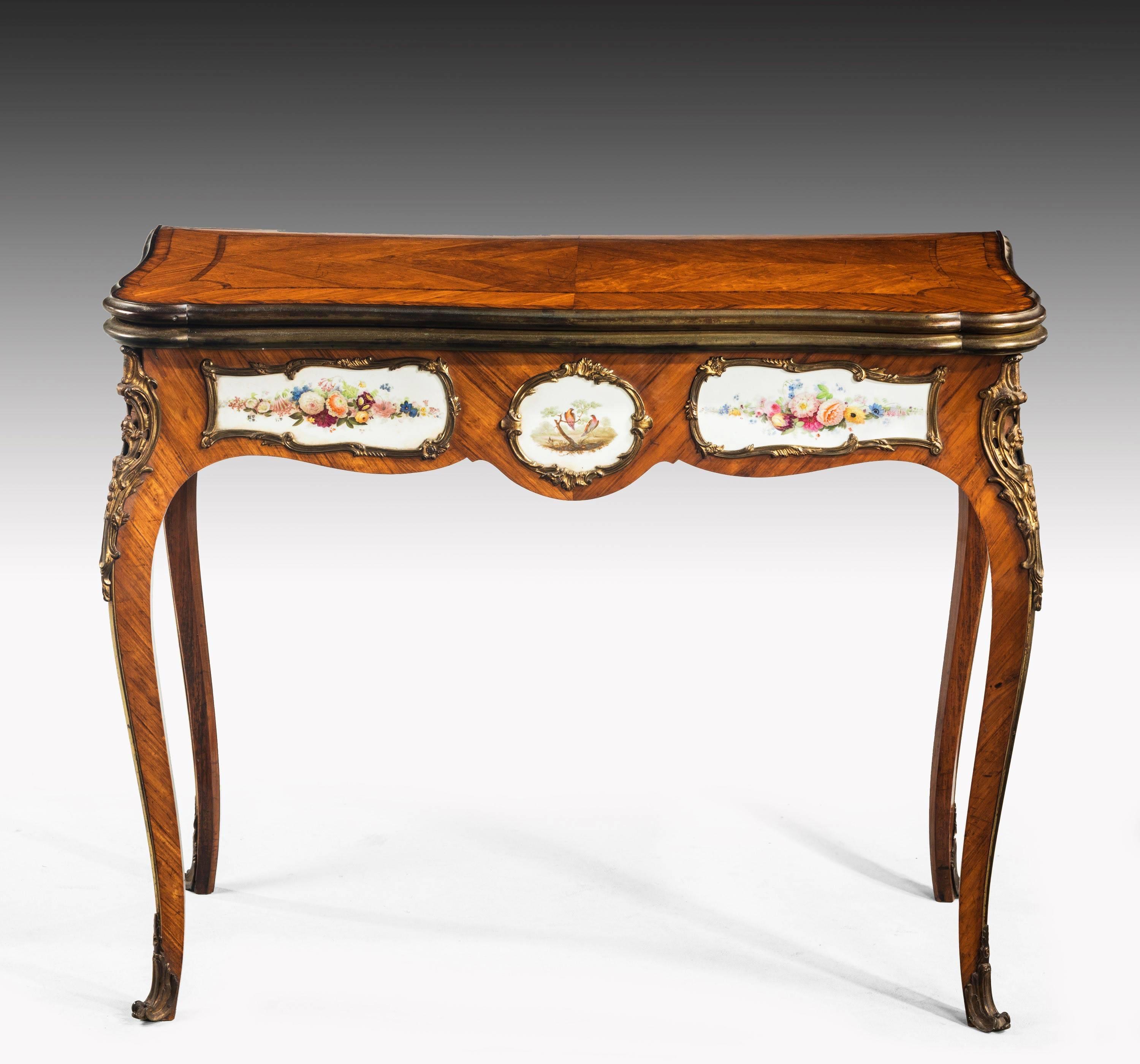 A quite exceptional kingwood games table. The top with a central base pattern which is finely quartered, within bandings and cross bandings and shaped Guinea wells. Crossbanded and banded decoration in rosewood and satinwood. The main fronts