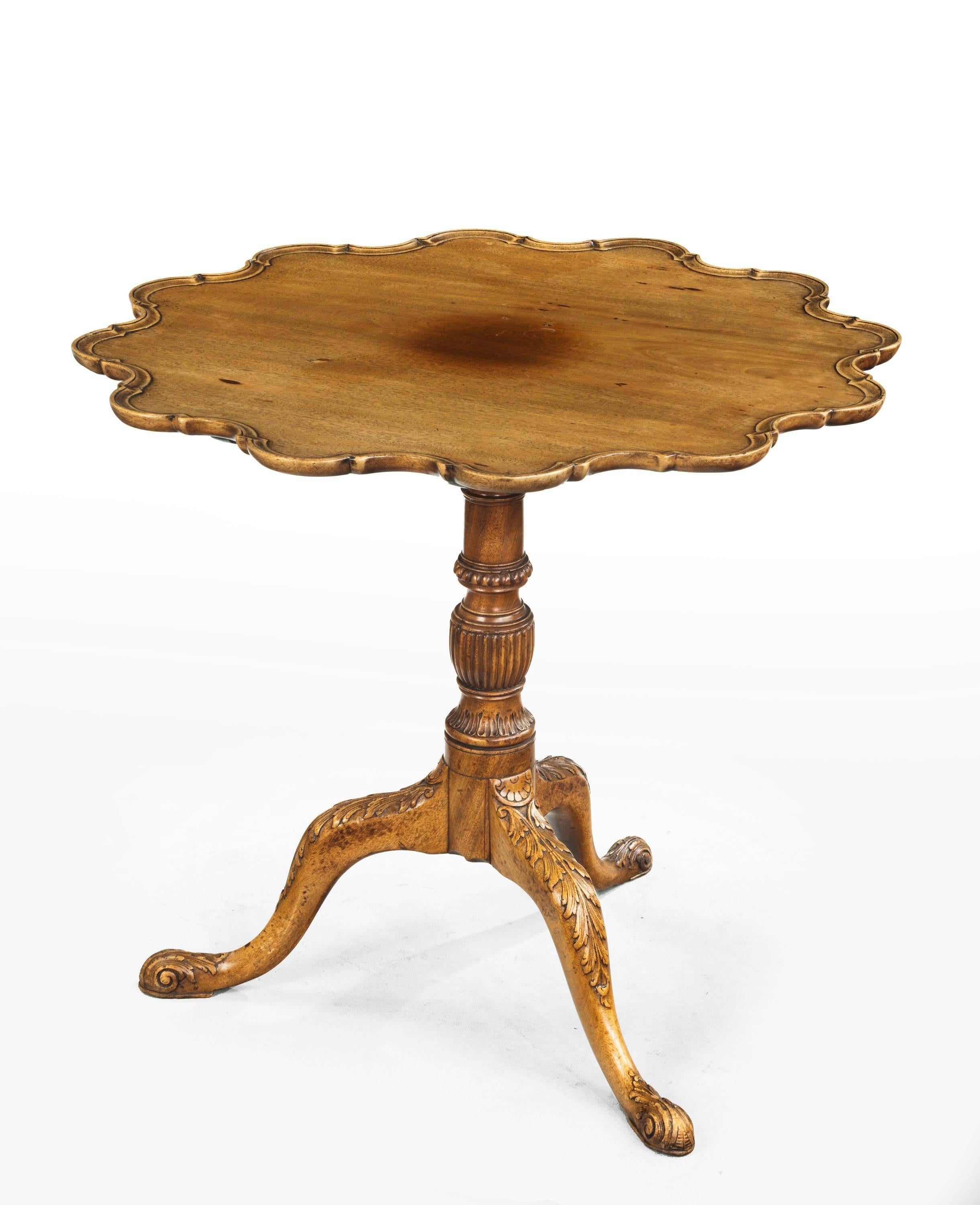 A extremely attractive mahogany shaped tilt table with a dish top. On beautifully carved central supports ending in cabriole legs with French feet. The design circa 1760 but the date 1890.

  