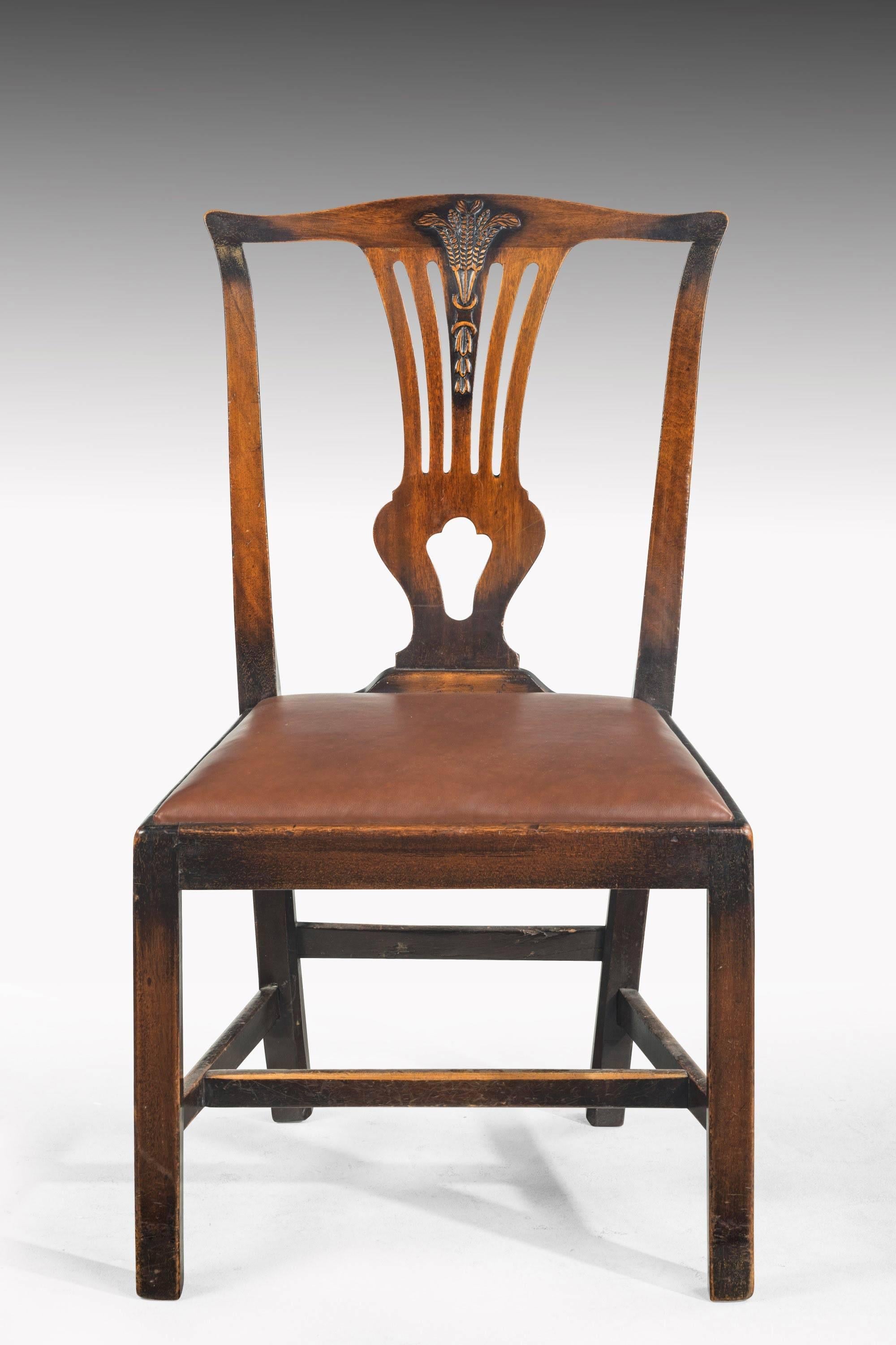 A set of five George III mahogany dining chairs, en suite with 7612. The pieced back splat topped with Prince of Wales feathers and hair bell detail to the lower section

Seat height 18.5 inches

 