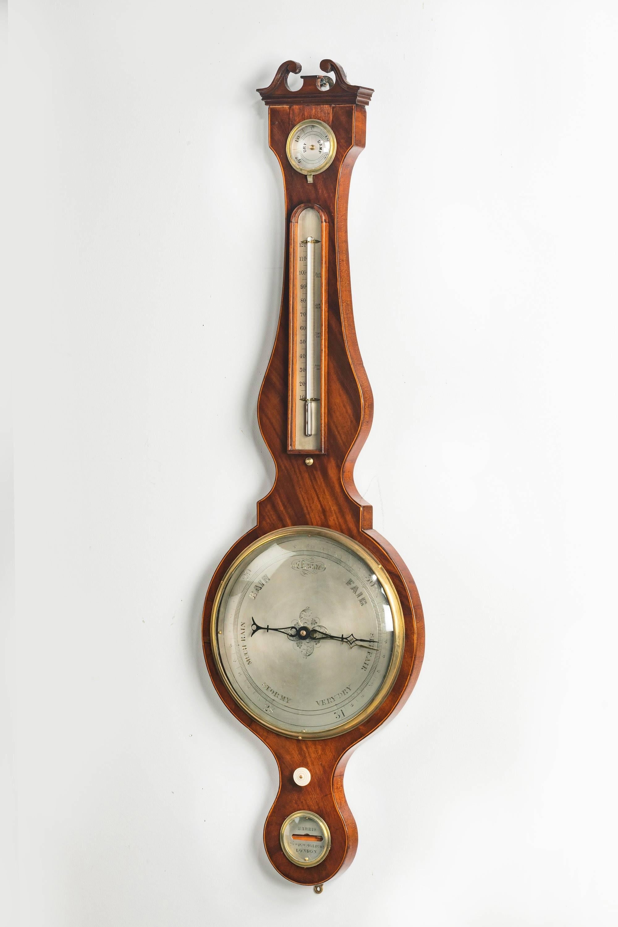 A mid-19th century mahogany and line inlaid wheel barometer and thermometer. With dry/damp dial and mercury thermometer above 10inch silvered dial. The storm dial marked Harris, 50, High Holborn, London.

Many makers with the surname Harris have