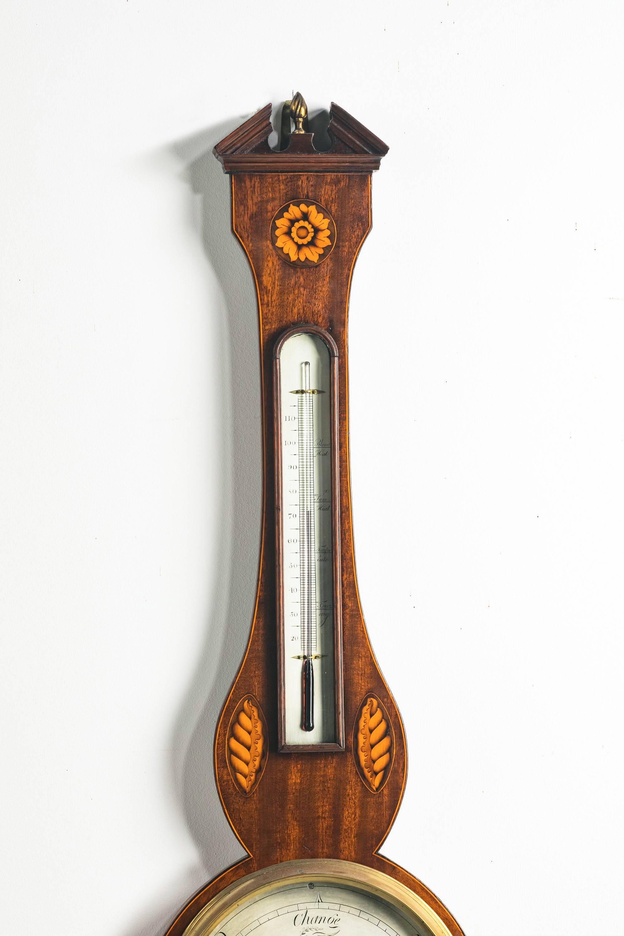 George III mahogany and marquetry inlaid wheel barometer and thermometer, 19th century, the oil thermometer above 8.5inch silvered dial marked CESER SCALFINI, TAUNTON.

 
