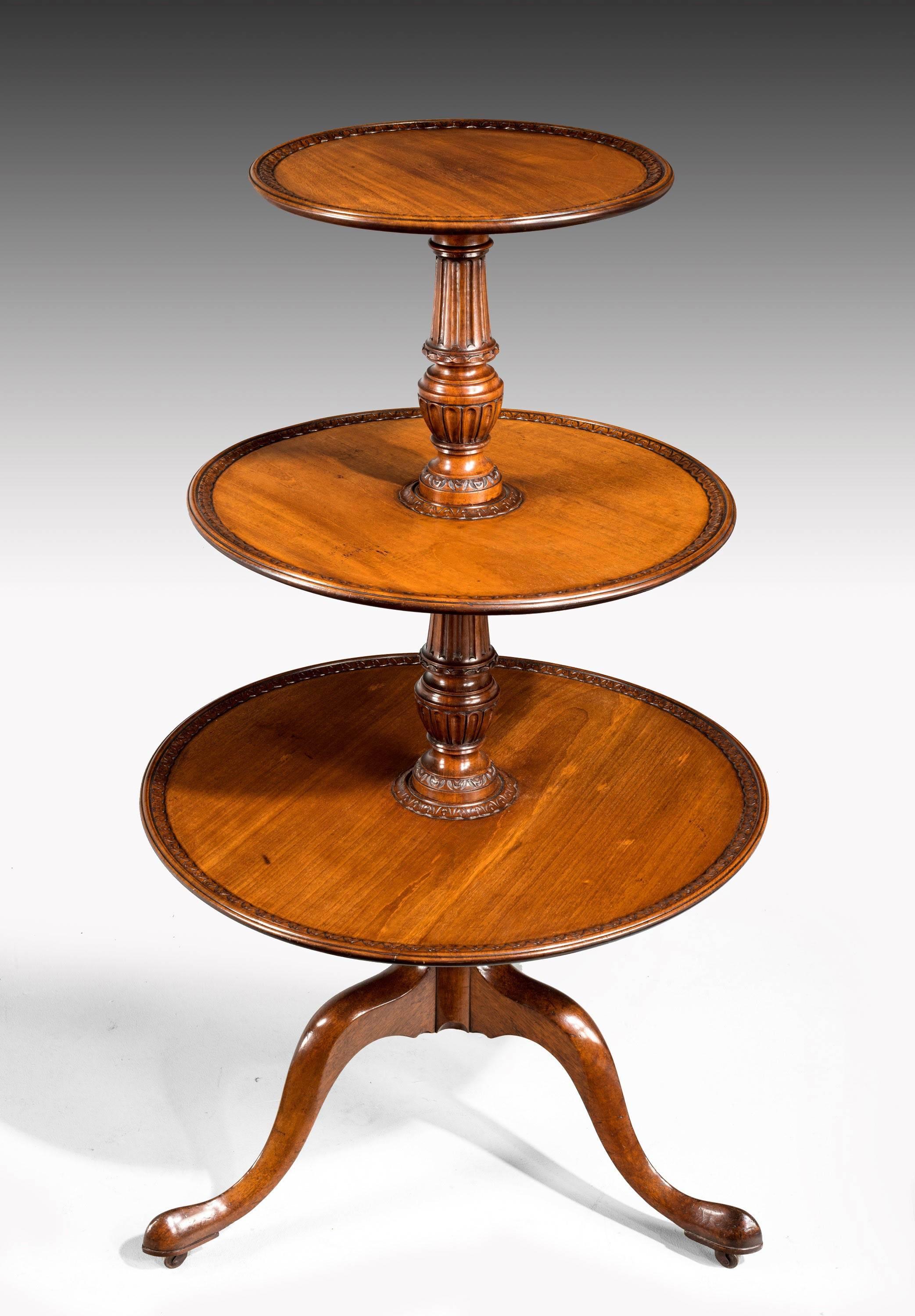 A George III period mahogany three tier dumbwaiter with unusual well carved detail to the edge of the trays and central stem. Cabriole legs. Excellent condition.

N.