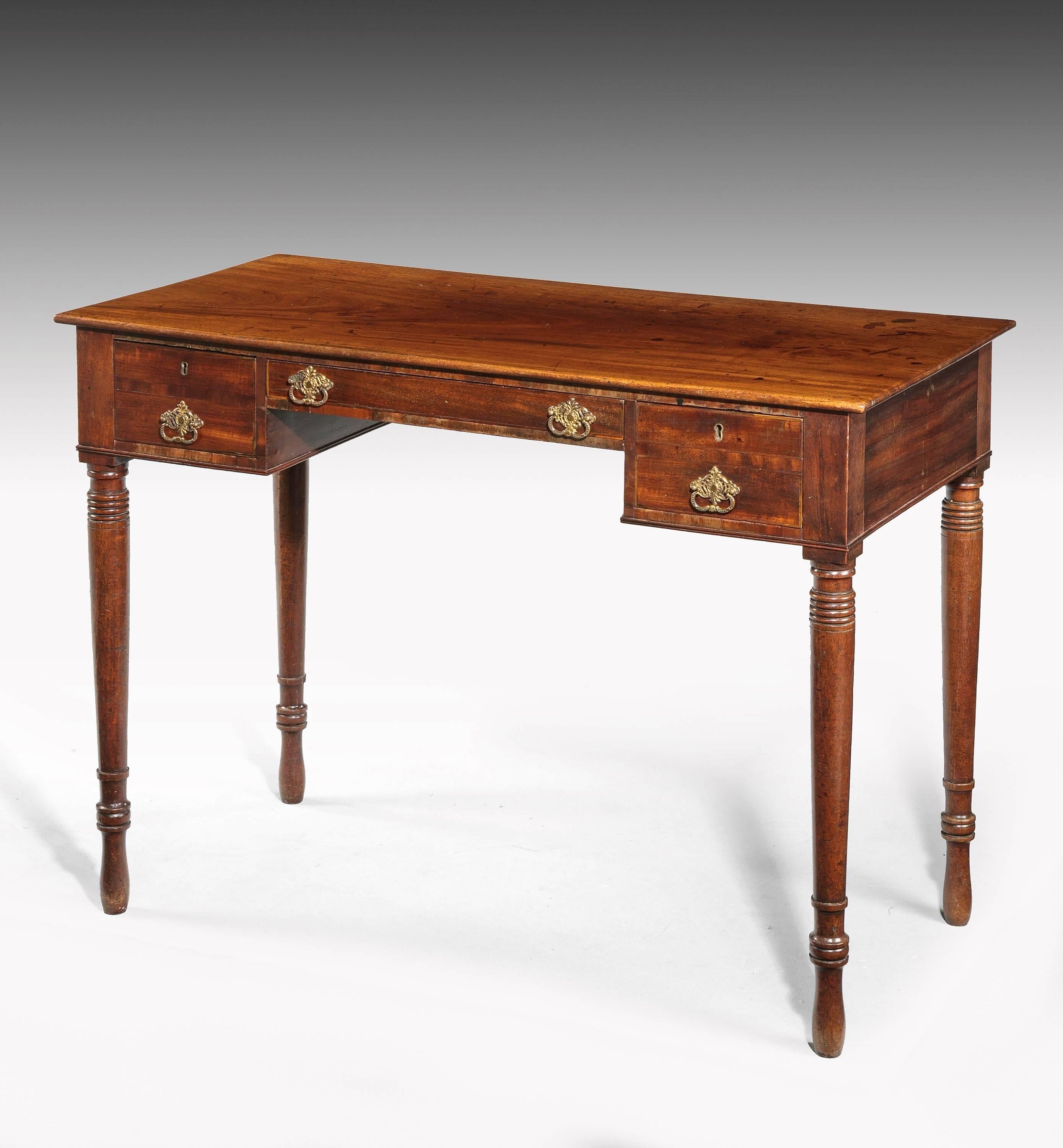 A Regency period mahogany side or writing table. The slender top section incorporating three drawers. On finely turned supports.