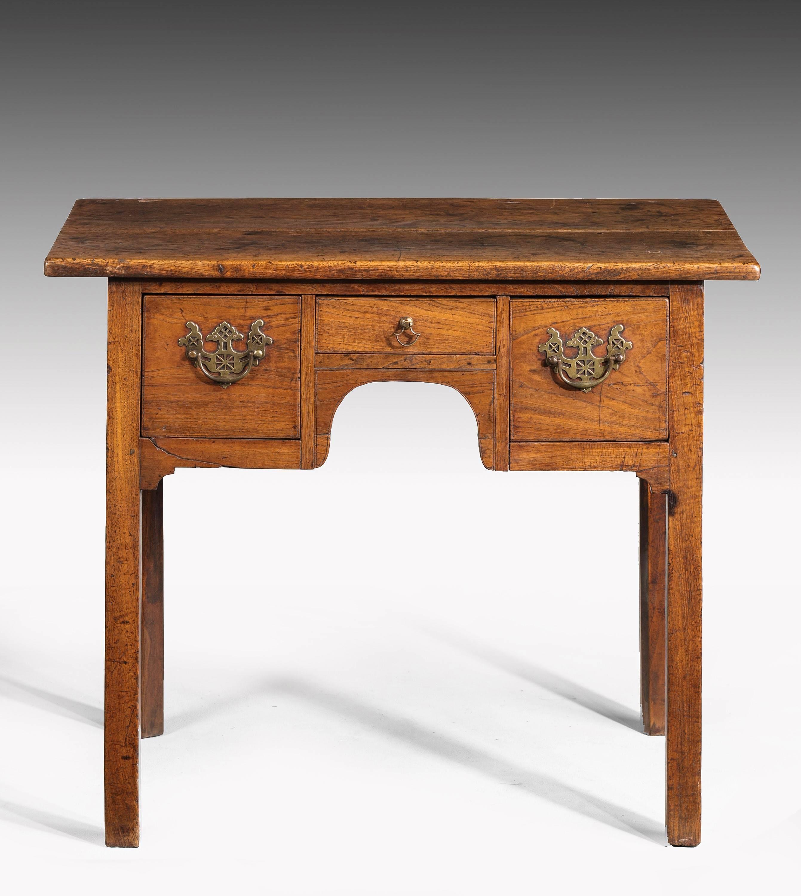 A George II period elm lowboy with three shaped drawers to the upper sections. Very good patina and colour.