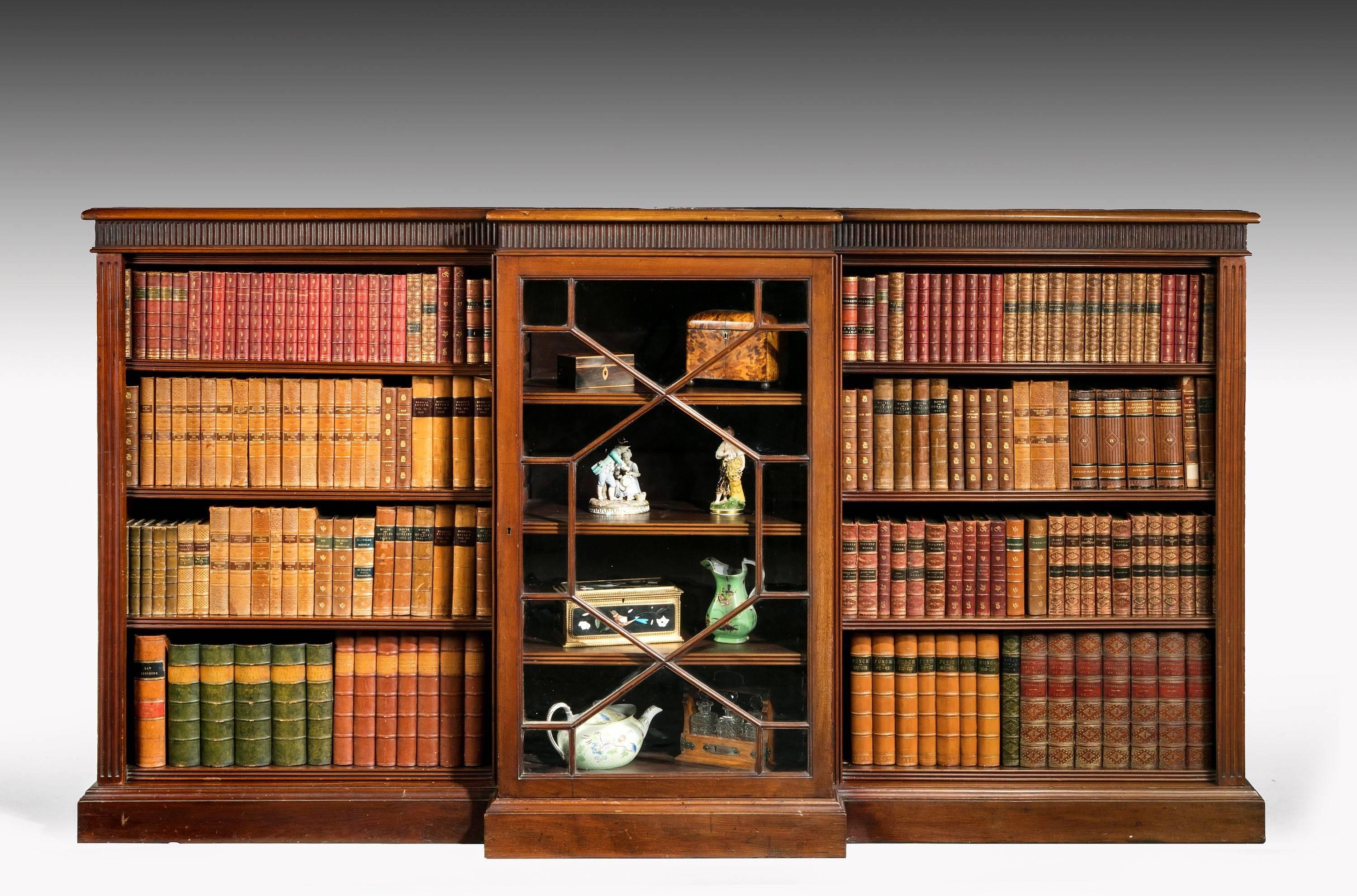 A mahogany low breakfront bookcase. The central section glazed with astragal bars. The sides adjustable.