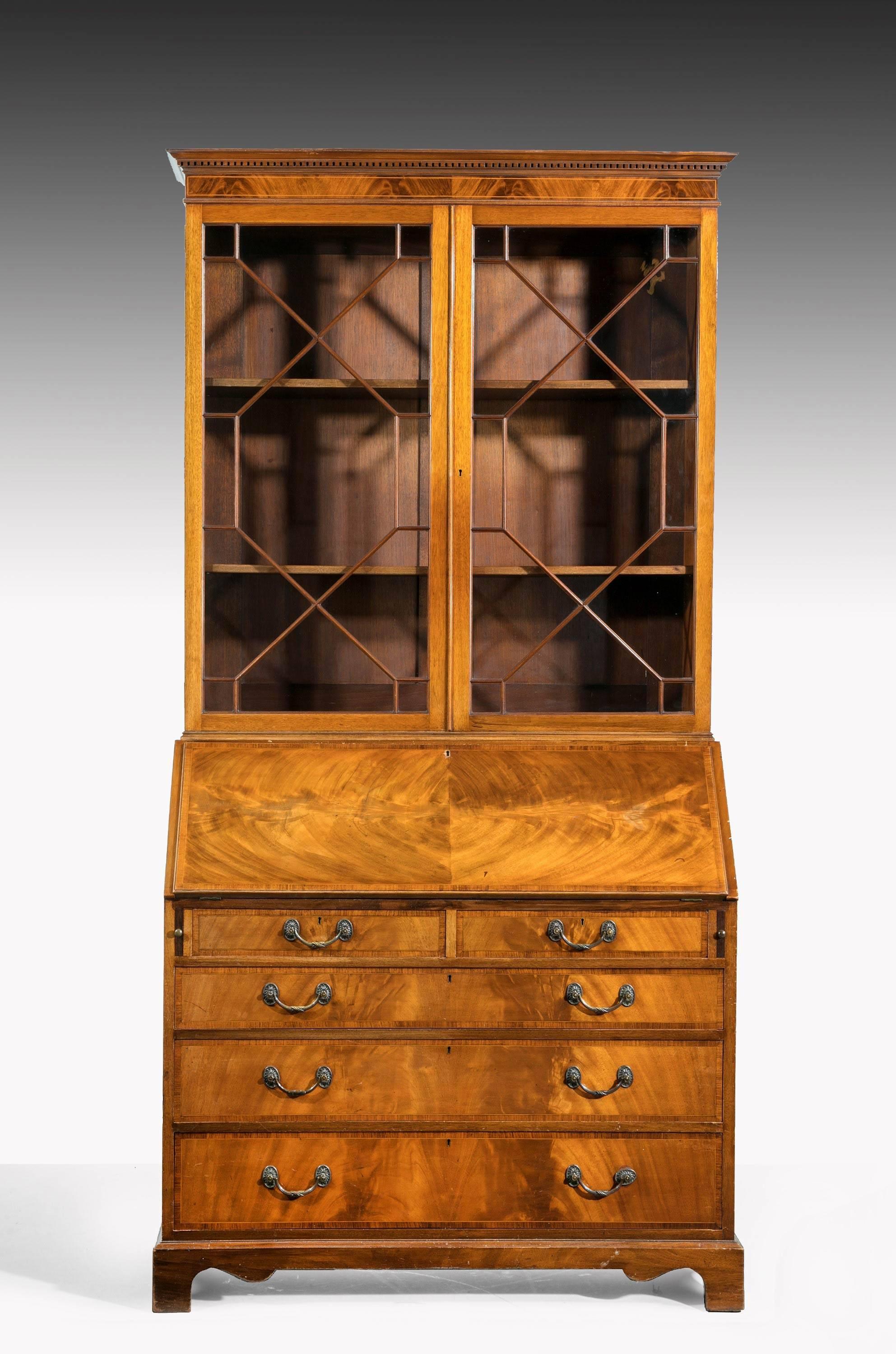 A George III period mahogany bureau bookcase with finely matched timbers throughout. Excellent overall condition. Astragal glazed top section. The interior with a fall front inset leather section incorporating pigeon holes and drawers.