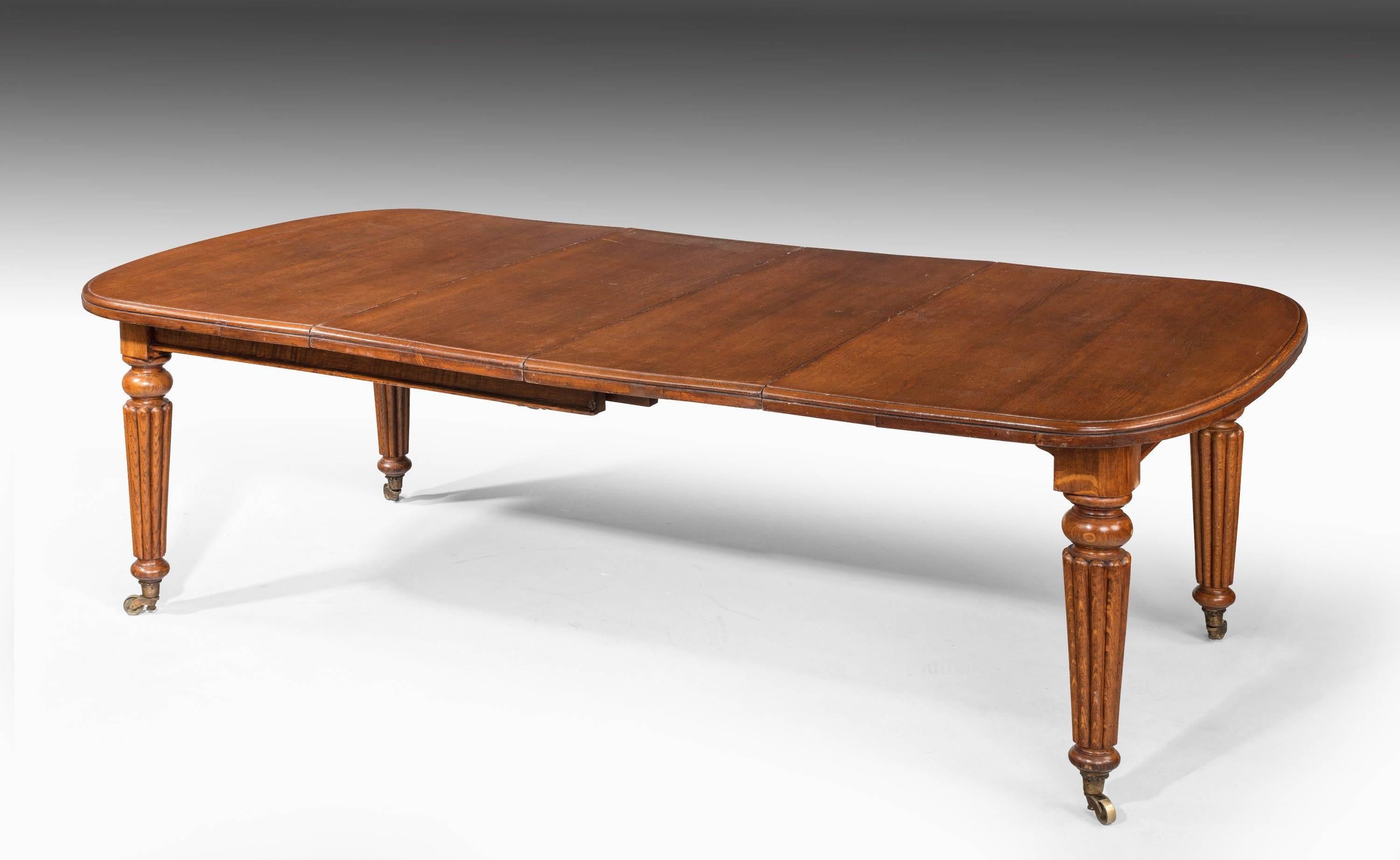 A late Regency period mahogany extending dining table. The supports very well carved with reeded decoration. Retaining the original shoes and castors.

With one leaf 73.5 inches.

With no leaves 57 inches.